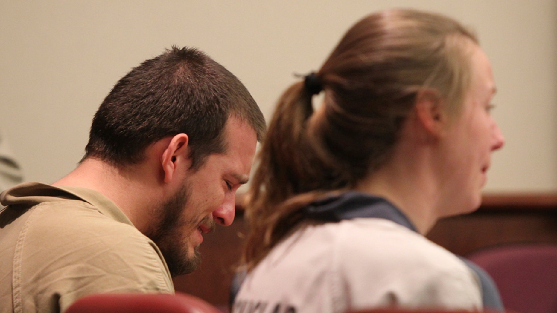 Jose Torres, left, weeps in his seat while during his sentencing at the Douglas County Courthouse in Douglasville, Ga., Monday, Feb. 27, 2017. Superior Court Judge William McClain sentenced Torres and Kayla Rae Norton, right, to lengthy prison terms Monday for their role in the disruption of a black child's birthday party with Confederate flags, racial slurs and armed threats. (Henry P. Taylor/Atlanta Journal-Constitution via AP)