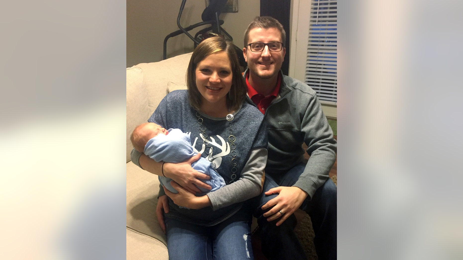 In the photo taken Dec. 24, 2016, by Luke Gardner with his cell phone on a timer, Luke and Hillary Gardner pose with their son Cade Lee in Baldwyn, Miss. The husband and wife share the same birthday, and now also their son who was born on Dec. 18. The odds of that happening are about one in 133,000 statisticians say. (Luke Gardner via AP)