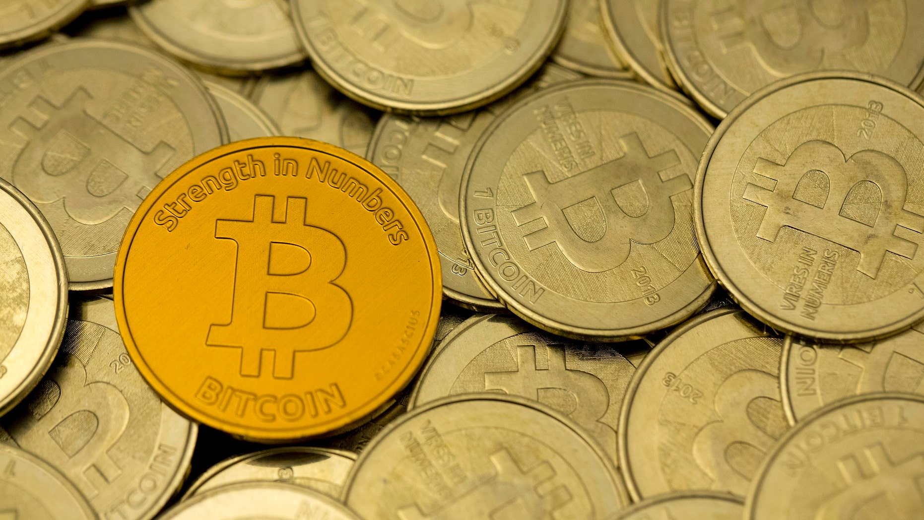 Photo illustration - Some of Bitcoin enthusiast Mike Caldwell's coins are pictured at his office in this photo illustration in Sandy, Utah, Jan. 31, 2014. (REUTERS/Jim Urquhart)