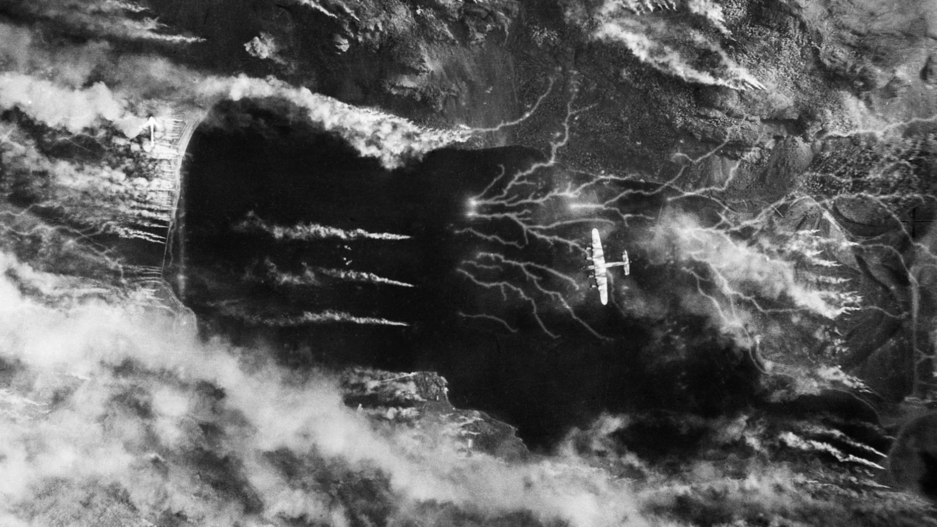 The Germans release a colossal smoke screen in an effort to hide their battleship Tirpitz, moored in Kaa Fjord, Norway, as it's attacked by a Lancaster on Sept. 15, 1944. (Credit: No. 5 Group RAF/IWM)
