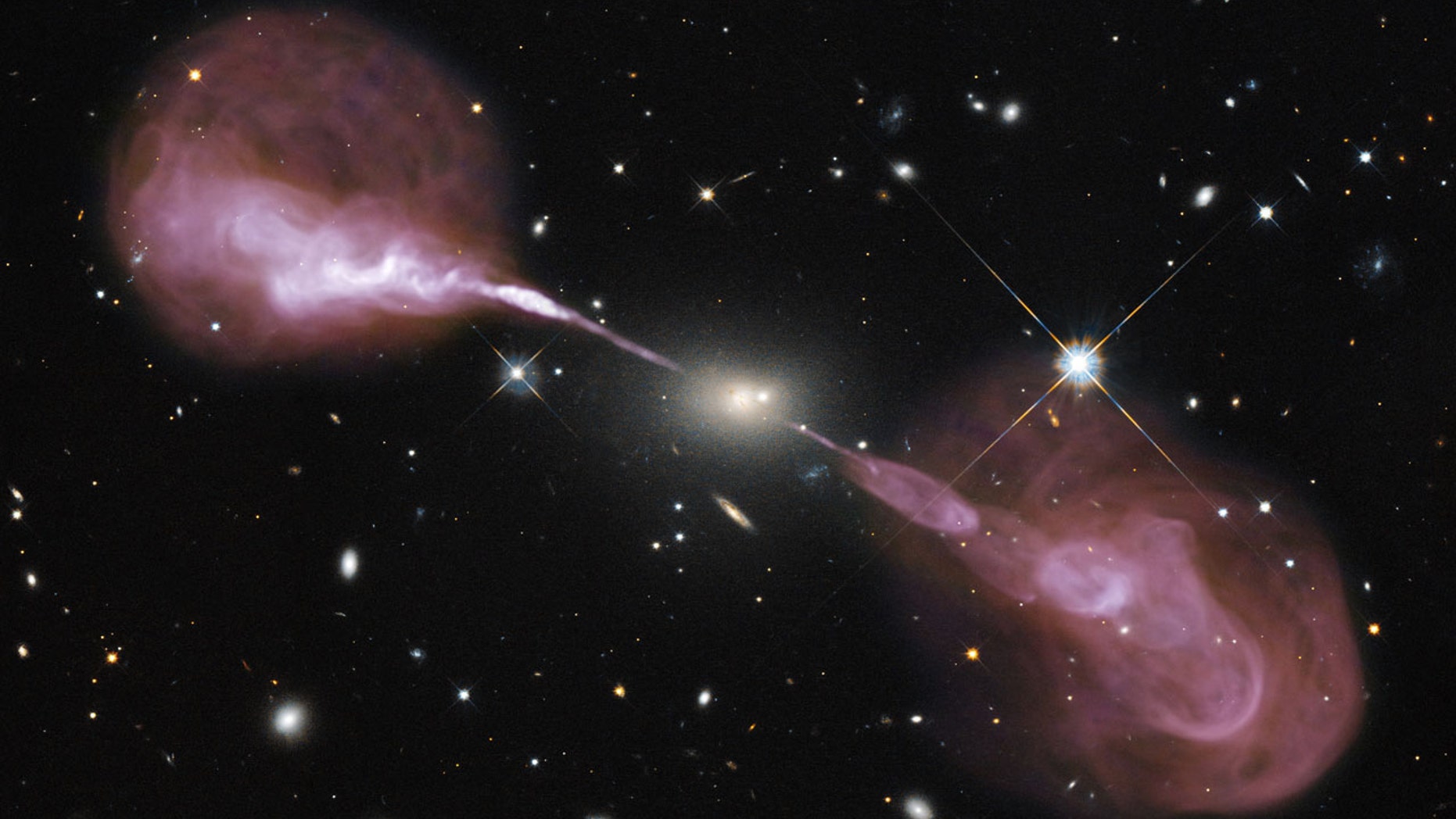 Fountains of hot gas erupting from a beastly black hole in the heart of a large galaxy known to radio astronomers as Hercules A. While astronomers have long seen the fallout of the presence of black holes on the stars and gas clouds around them, none have ever actually stared directly into its abyss.