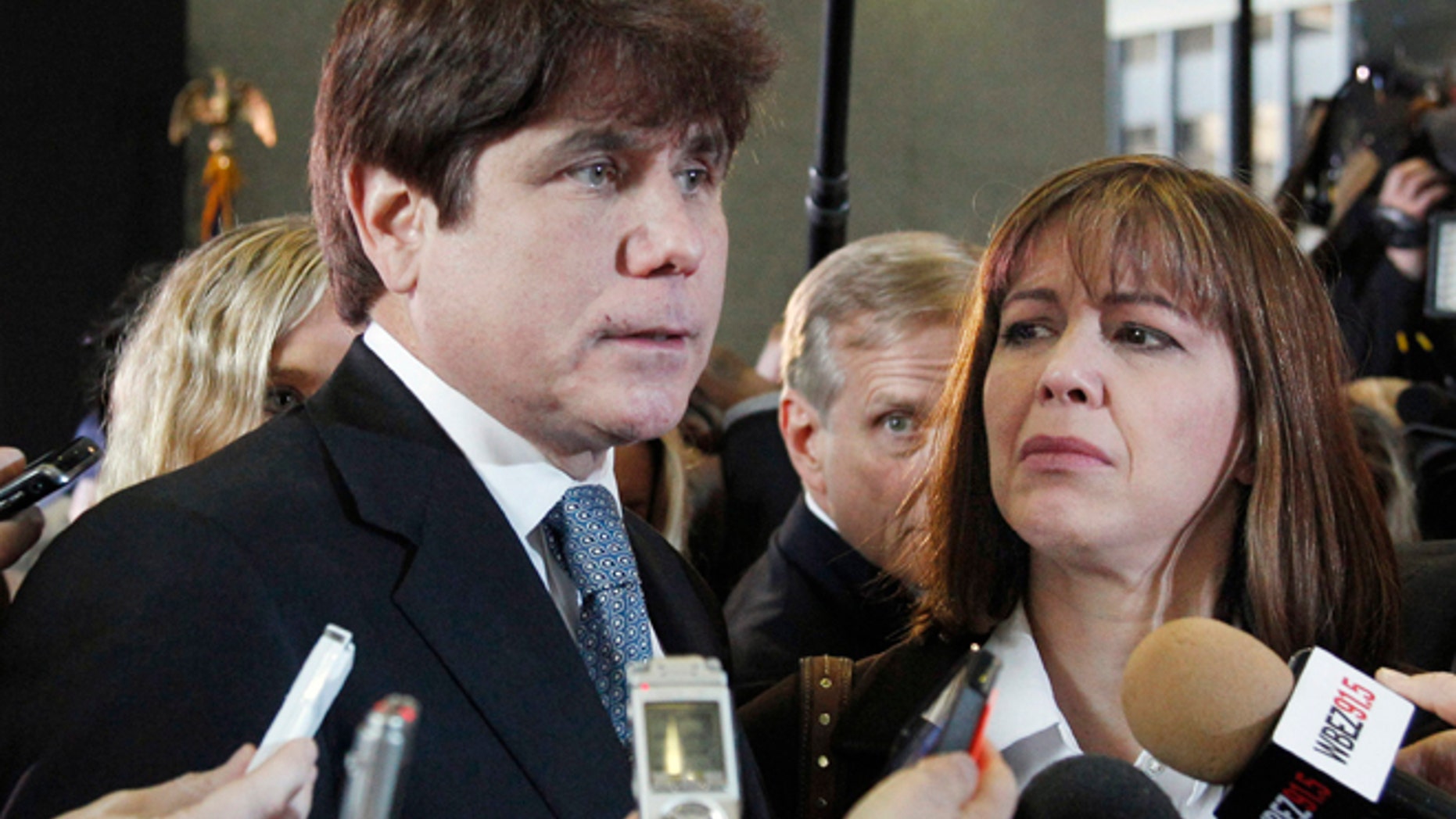 Dec. 7, 2011: Former Illinois Gov. Rod Blagojevich, left, speaks to reporters as his wife, Patti, listens at the federal building in Chicago, after Blagojevich was sentenced to 14 years on 18 corruption counts.