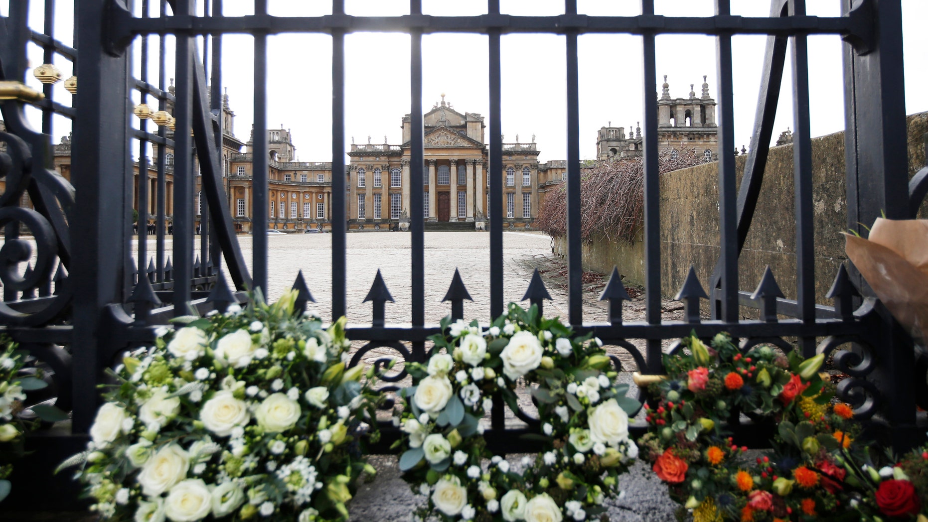 Floral tributes are seen at the gates of Blenheim Palace before the funeral of the 11th Duke of Marlborough, John Spencer-Churchill, in Woodstock, southern England October 24, 2014. His Blenheim Palace home is a Unesco World Heritage Site, and the birthplace of Winston Churchill.