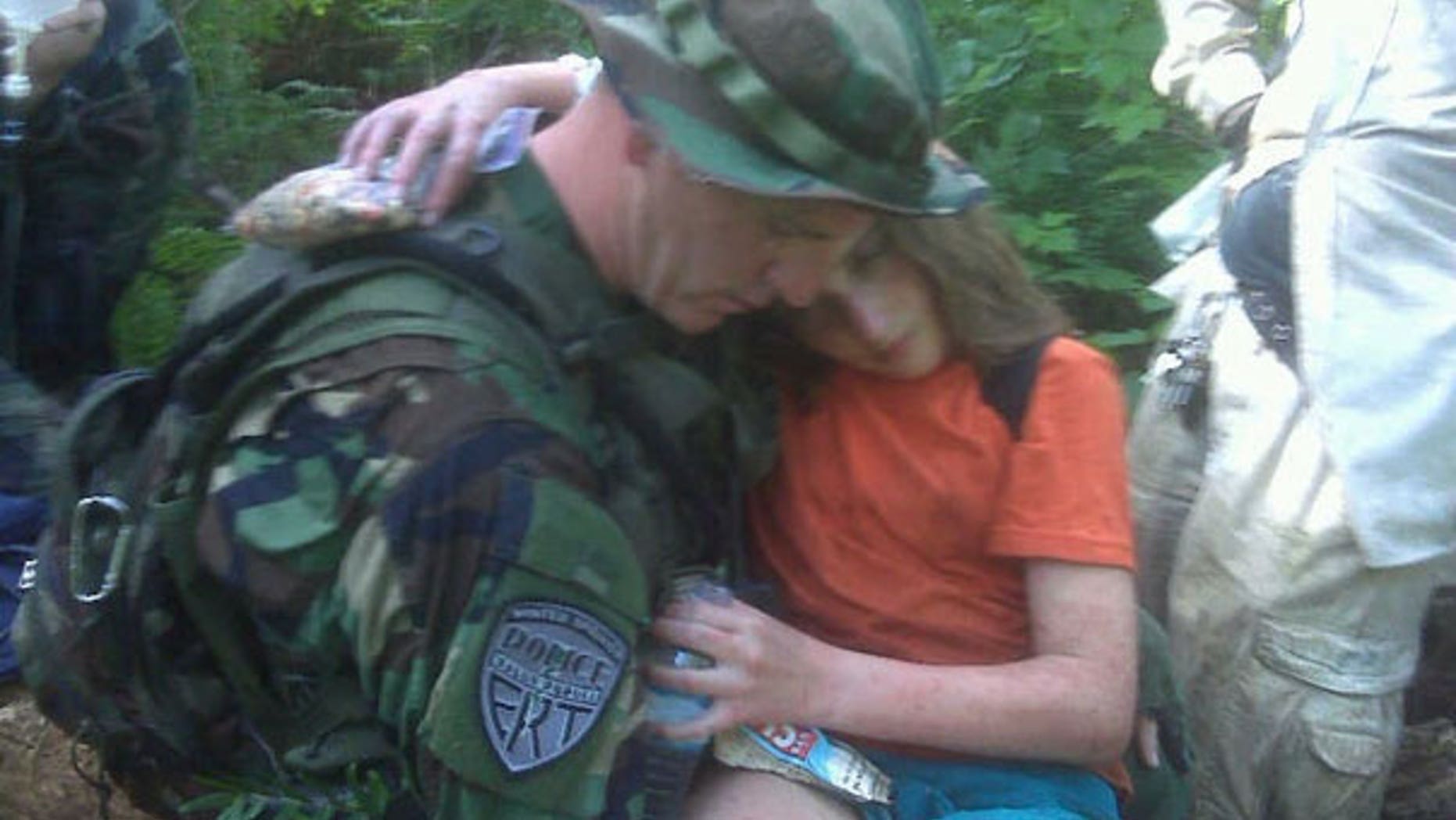 A Winter Springs Police officer carries Nadia Bloom out of an alligator-infested swamp. (Winter Springs Police)