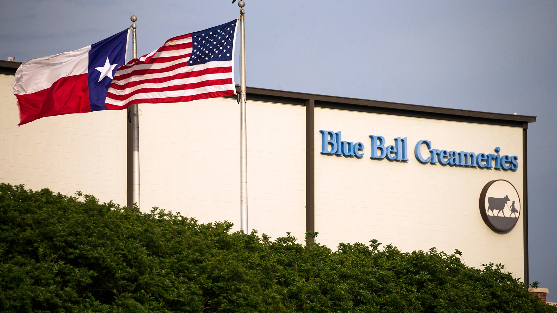 FILE - In thus April 23, 2015 file photo, flags flutter in the breeze outside of the Blue Bell Creameries in Brenham, Texas. A supplier of cookie dough that Blue Bell Creameries is blaming for a possible listeria contamination of some of its ice cream products says its product tested negative for the pathogen before being sent to the Texas-based company. In a statement Thursday, Sept. 22, 2016, Iowa-based Aspen Hills said the "positive listeria results were obtained by Blue Bell only after our product had been in their control for almost two months." (Smiley N. Pool/The Dallas Morning News via AP, File)
