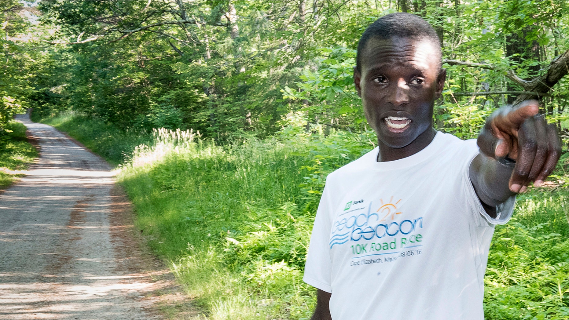 In this July 5, 2017, photo, Moninda Marube points to the house on Whitman Spring Trail in Auburn, Maine, while recounting his encounter with a pair of bears that chased him.