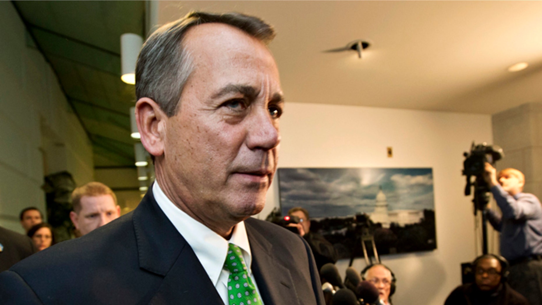 Jan. 1, 2013: Speaker of the House John Boehner walks past reporters on Capitol Hill.