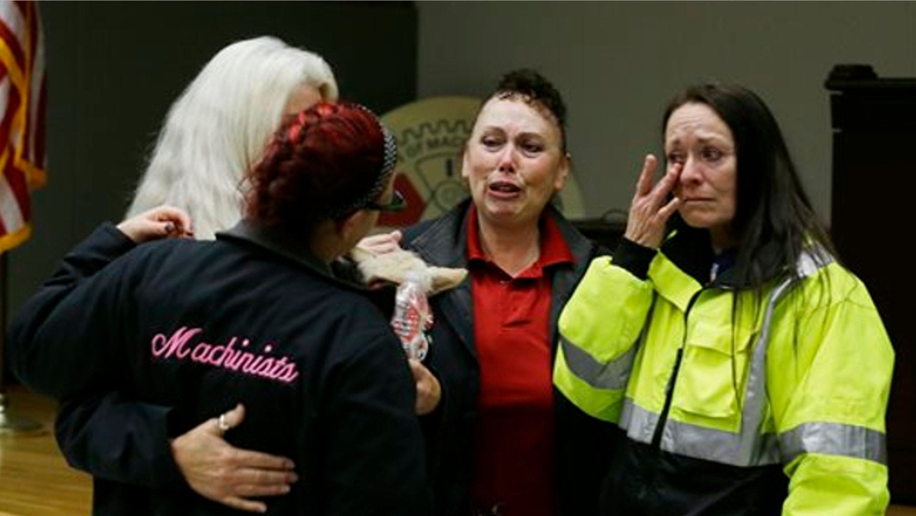 Jan. 3, 2014: Boeing workers cry after learning that voters in District 751 of the Boeing machinists union voted to accept Boeing's latest contract offer to keep the assembly of the Boeing 777X airplane in Washington state in Seattle.