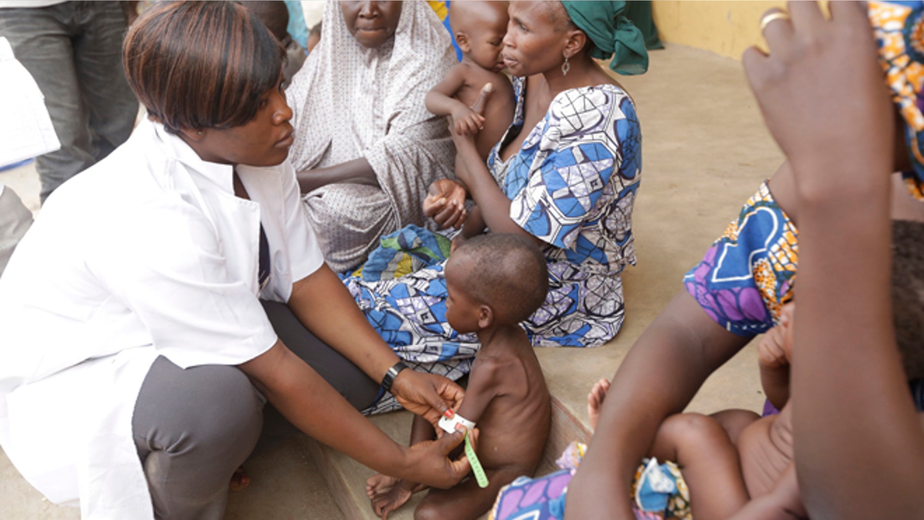 May 3, 2015: A doctor attends to a Malnourished child as women and children rescued by Nigerian soldiers wait to receive treatment at a refugee camp in Yola, Nigeria.