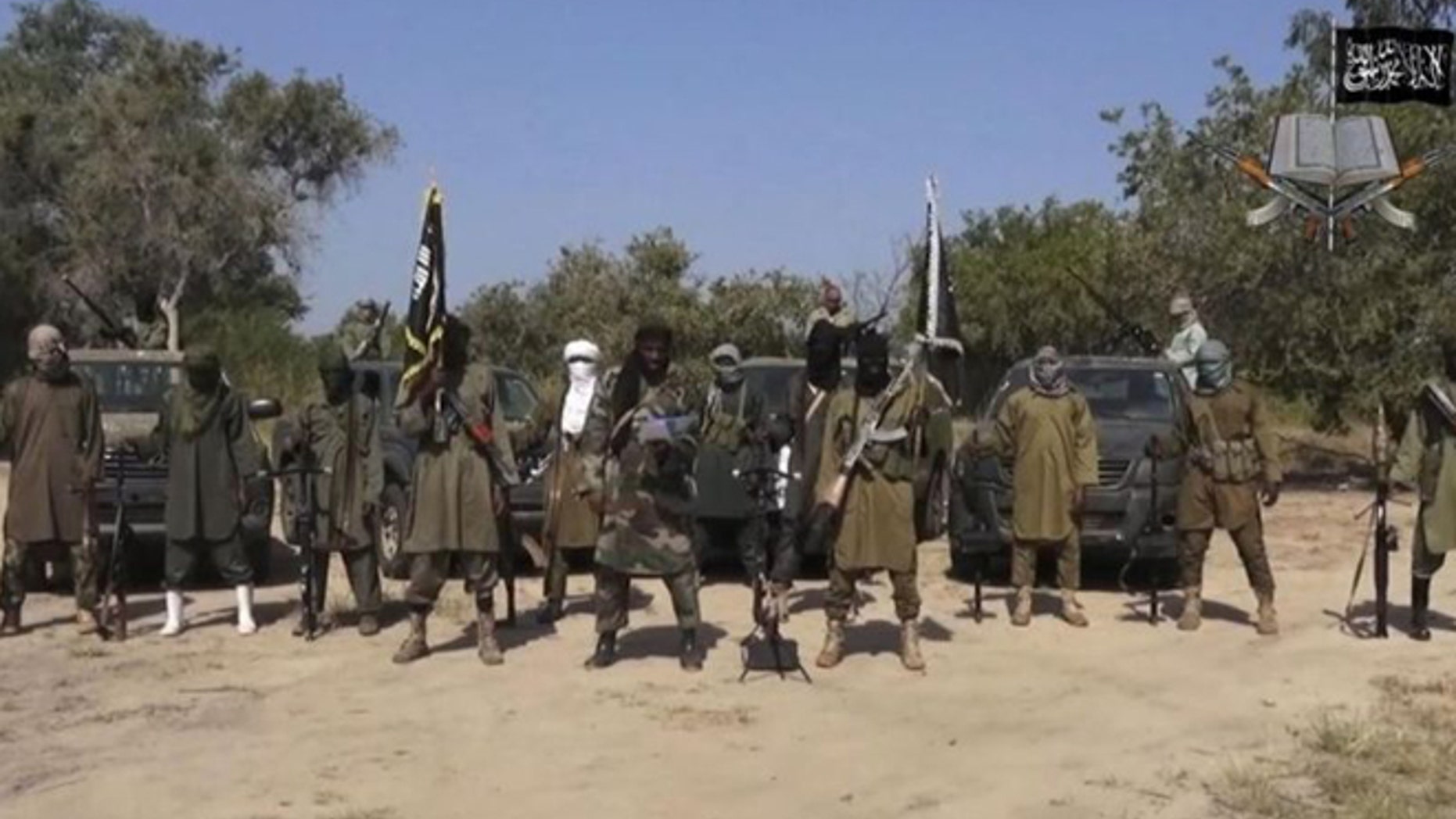 This file image taken from video released Oct. 31, 2014, by Boko Haram, shows Abubakar Shekau, center, the former leader of Nigeria's Islamic extremist group.