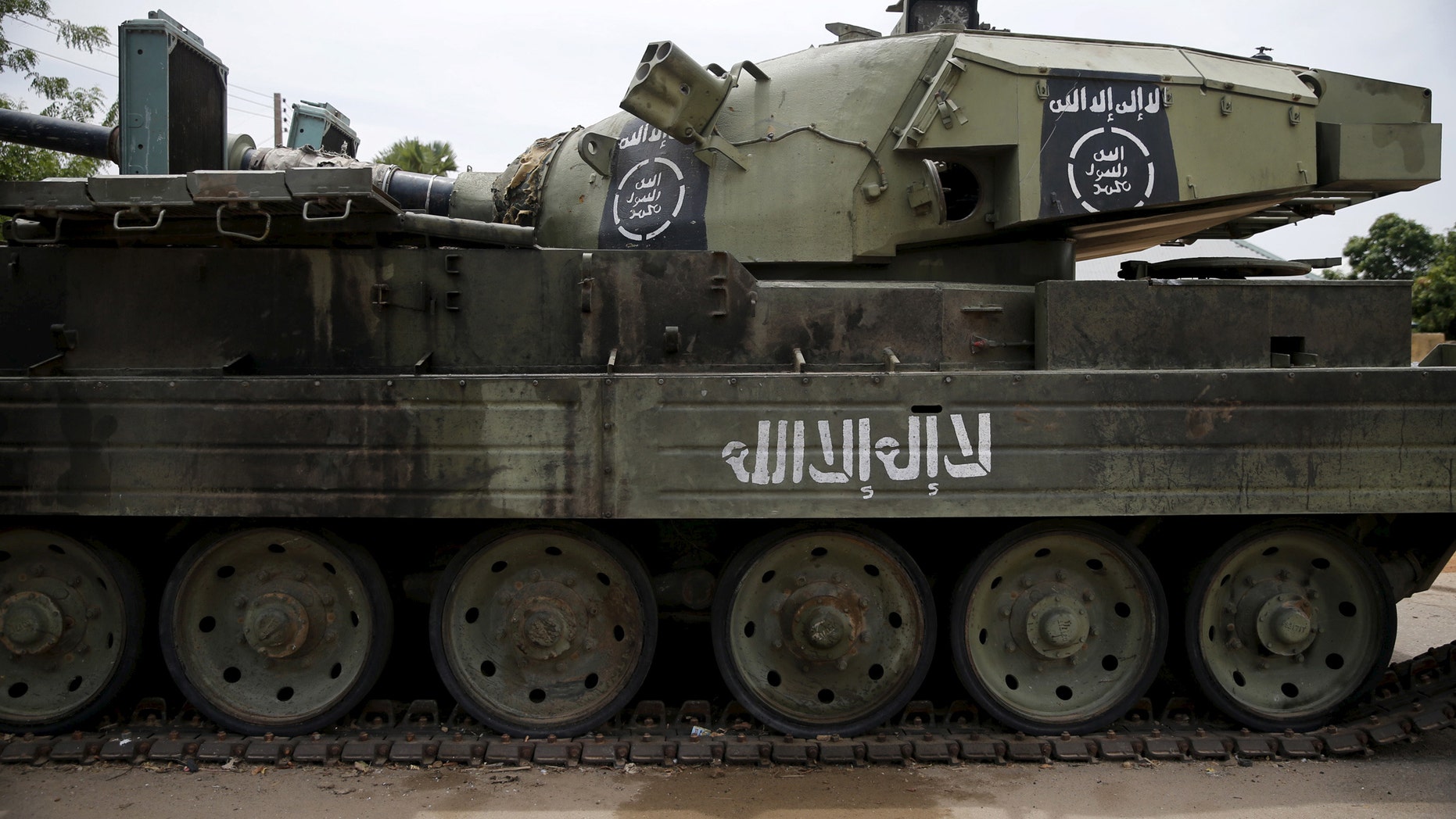 File photo - An armoured tank is seen abandoned along a road in Bazza town, after the Nigerian military recaptured it from Boko Haram, in Adamawa state May 10, 2015. (REUTERS/Akintunde Akinleye)