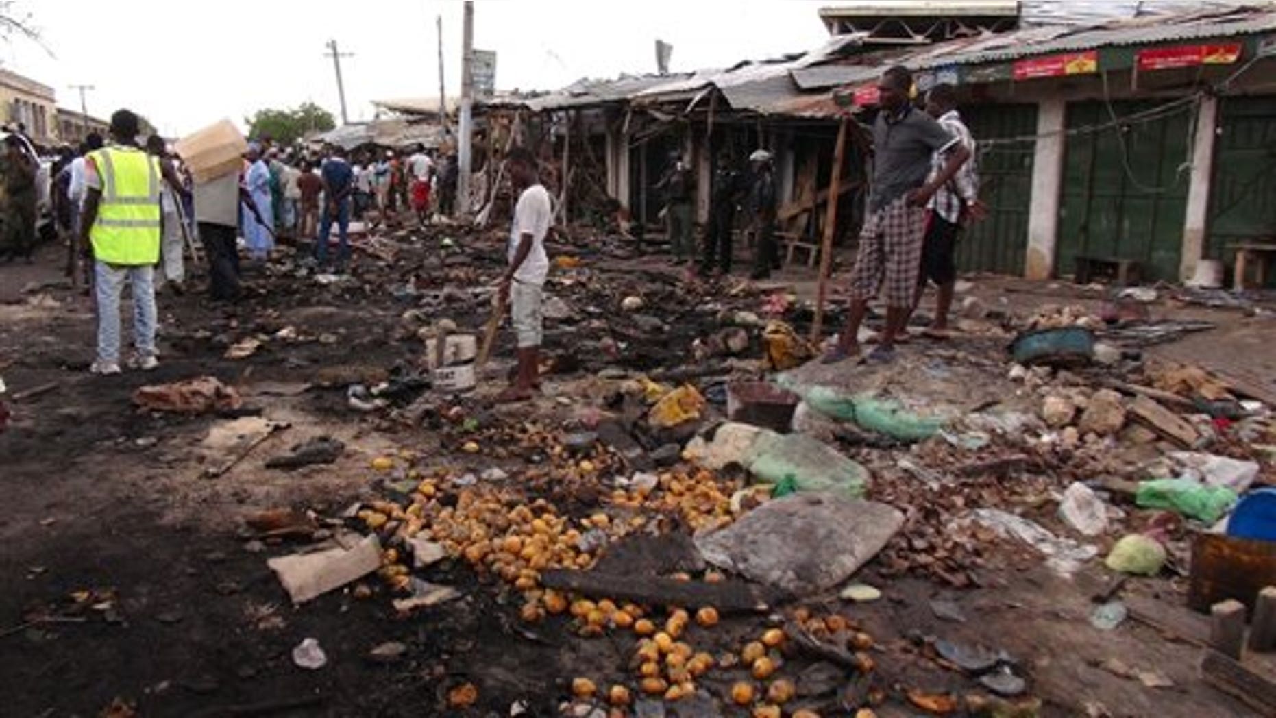 People gather on July 2, 2014, at the scene of a car bomb explosion, at the central market, in Maiduguri, Nigeria, the birthplace of terror group Boko Haram. (AP Photo/Jossy Ola)