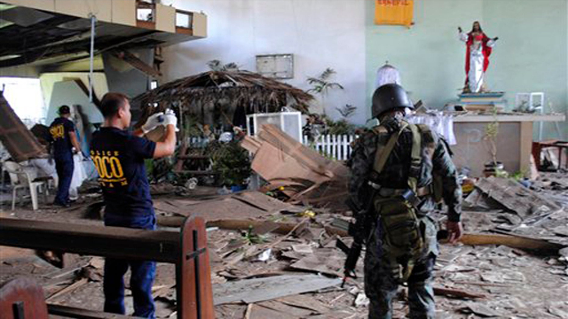 Dec. 25, 2010: Philippine National Police investigators inspect the damage of the Sacred Heart Catholic chapel following an explosion during a Christmas Day mass at the volatile island of Jolo, Sulu province in southern Philippines.