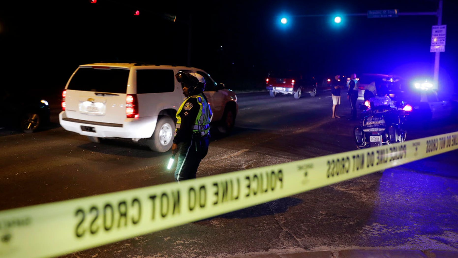 Police continue to restrict access to the neighborhood at the site of Sunday's explosion, early Monday, March 19, 2018, in Austin, Texas. Multiple people were injured in the explosion Sunday night, and police warned nearby residents to remain indoors overnight as investigators looked for possible links to other package bombings elsewhere in the city this month. (AP Photo/Eric Gay)