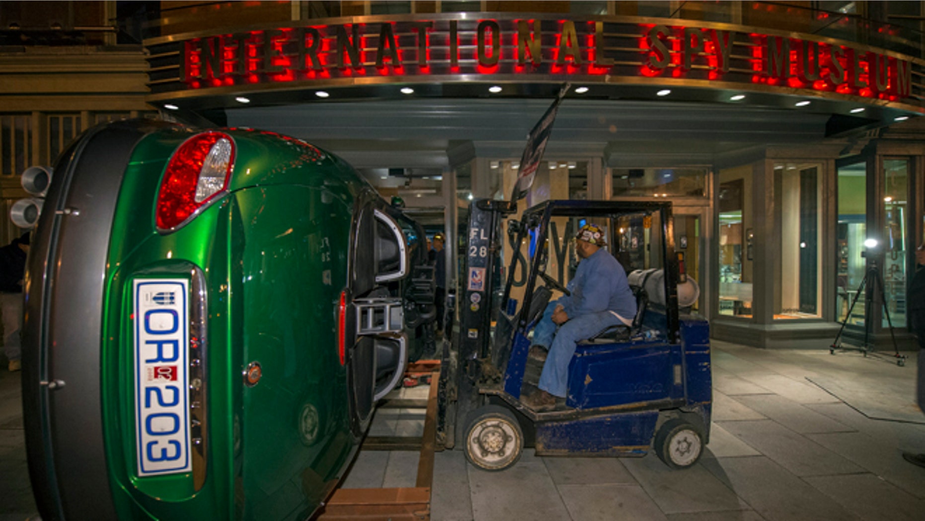 Nov. 8, 2012: Workers move the Jaguar XKR used in the James Bond Movie "Die Another Day" through the front doors of the International Spy Museum in Washington.