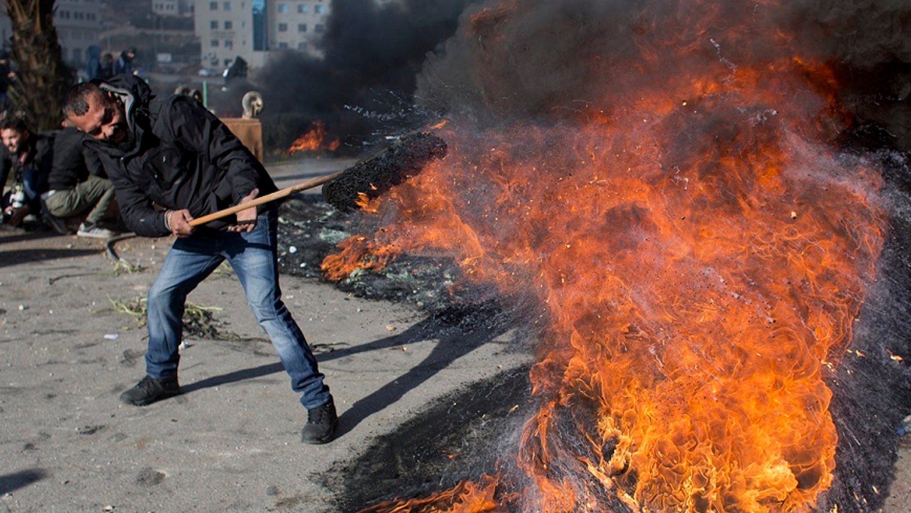 A Palestinian protester burns tires to protest President Trump's decision to move the U.S. Embassy in Israel to Jerusalem.