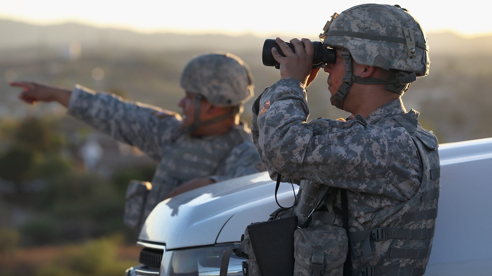NOGALES, AZ - JUNE 22: U.S. Army National Guardsmen scan the U.S.-Mexico border on June 22, 2011 in Nogales, Arizona. The Pentagon recently extended the deployment of some 1,200 guardsmen who were deployed last year to assist with border security on the U.S.-Mexico border until September 30. Soldiers at Early Identification Team (EIT) observation posts in Nogales work 24 hour shifts, each taking turns resting for 4 hours during the night. The National Guard troops are strictly on surveillance duty, although they are armed and have been credited with helping U.S. Border Patrol agents arrest up to 17,000 illegal immigrants crossing into the United States. (Photo by John Moore/Getty Images)