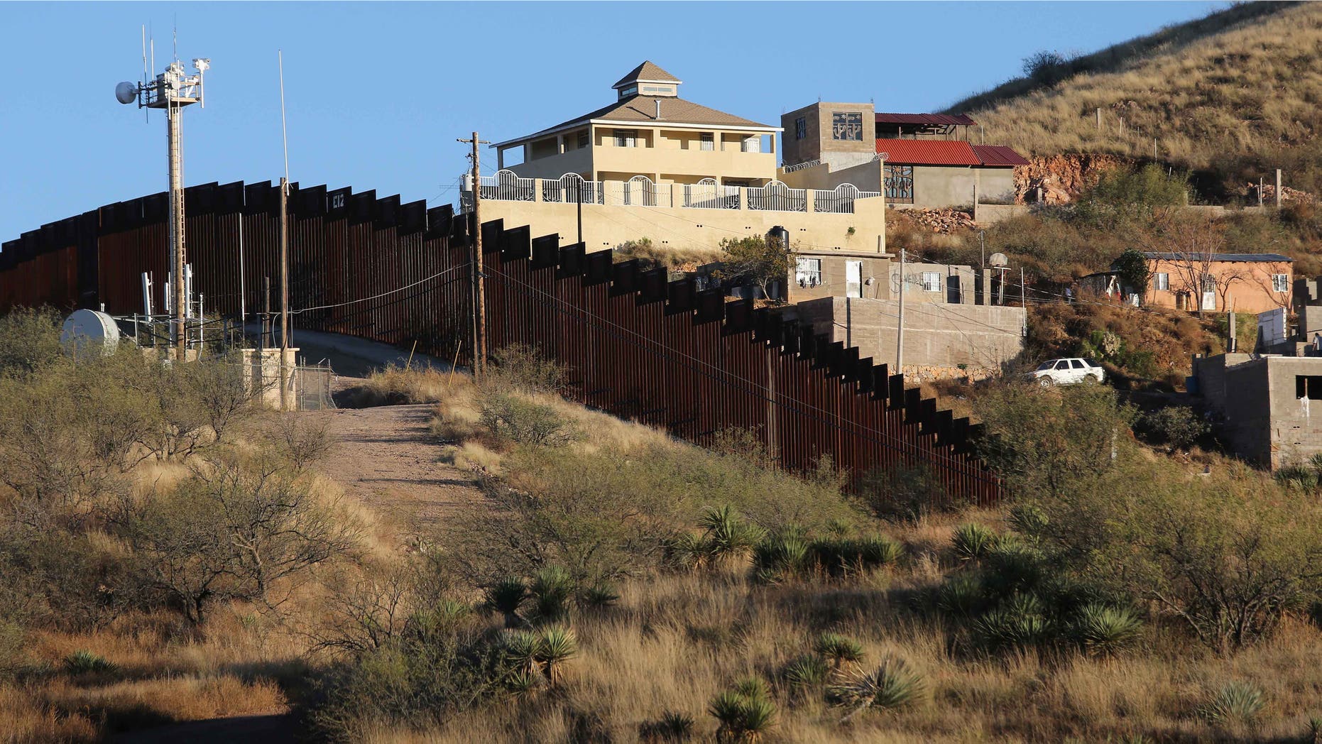 NOGALES, AZ - DECEMBER 09: A suspected narco obvervation house stands on the Mexican side of the U.S.-Mexico border fence on December 9, 2014 near Nogales, Arizona. With increased manpower and funding in recent years, the Border Patol has seen the number illegal crossings and apprehensions of undocumented immigrants decrease in the Tucson sector. Agents are waiting to see if the improved U.S. economy and housing construction will again draw more immigrants from the south. (Photo by John Moore/Getty Images)
