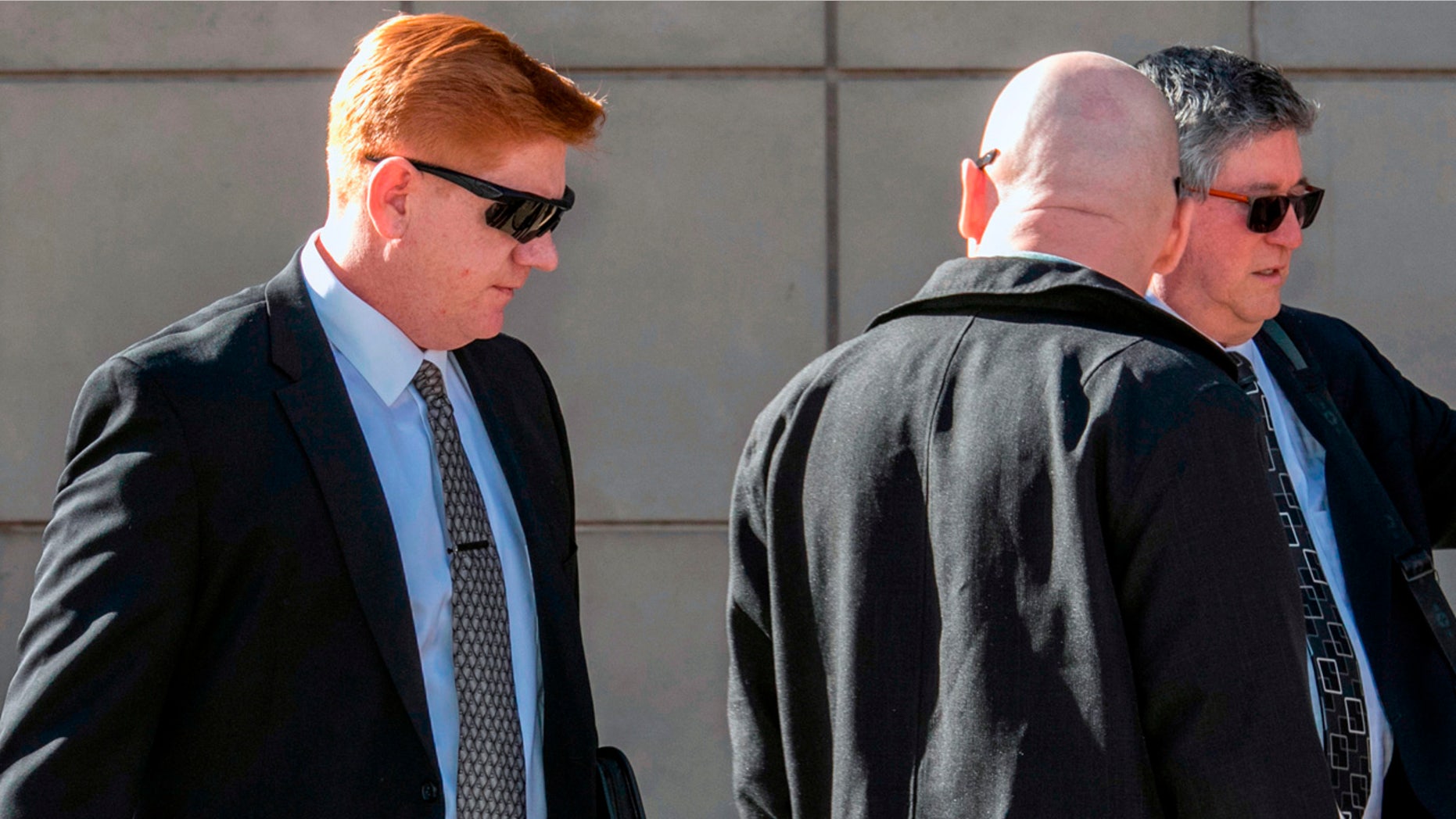 Lonnie Swartz, left, walks into federal court in Tucson, Ariz. last month.