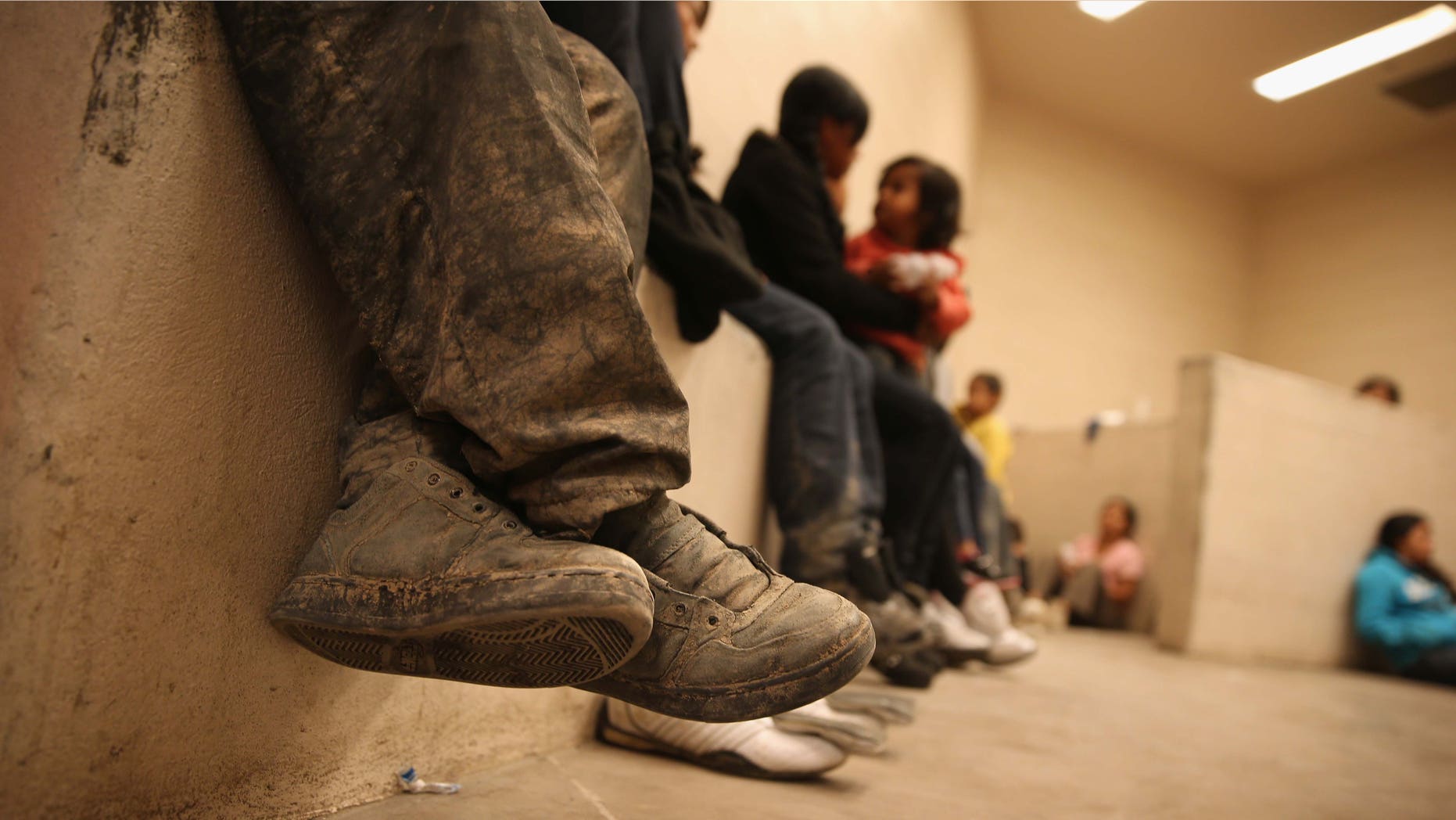 MCALLEN, TX - SEPTEMBER 08: Women and children sit in a holding cell at a U.S. Border Patrol processing center after being detained by agents near the U.S.-Mexico border on September 8, 2014 near McAllen, Texas. Thousands of immigrants, many of them families and unaccompanied minors, continue to cross illegally into the United States, although the numbers are down from a springtime high. Texas' Rio Grande Valley area is the busiest sector for illegal border crossings into the United States. (Photo by John Moore/Getty Images)