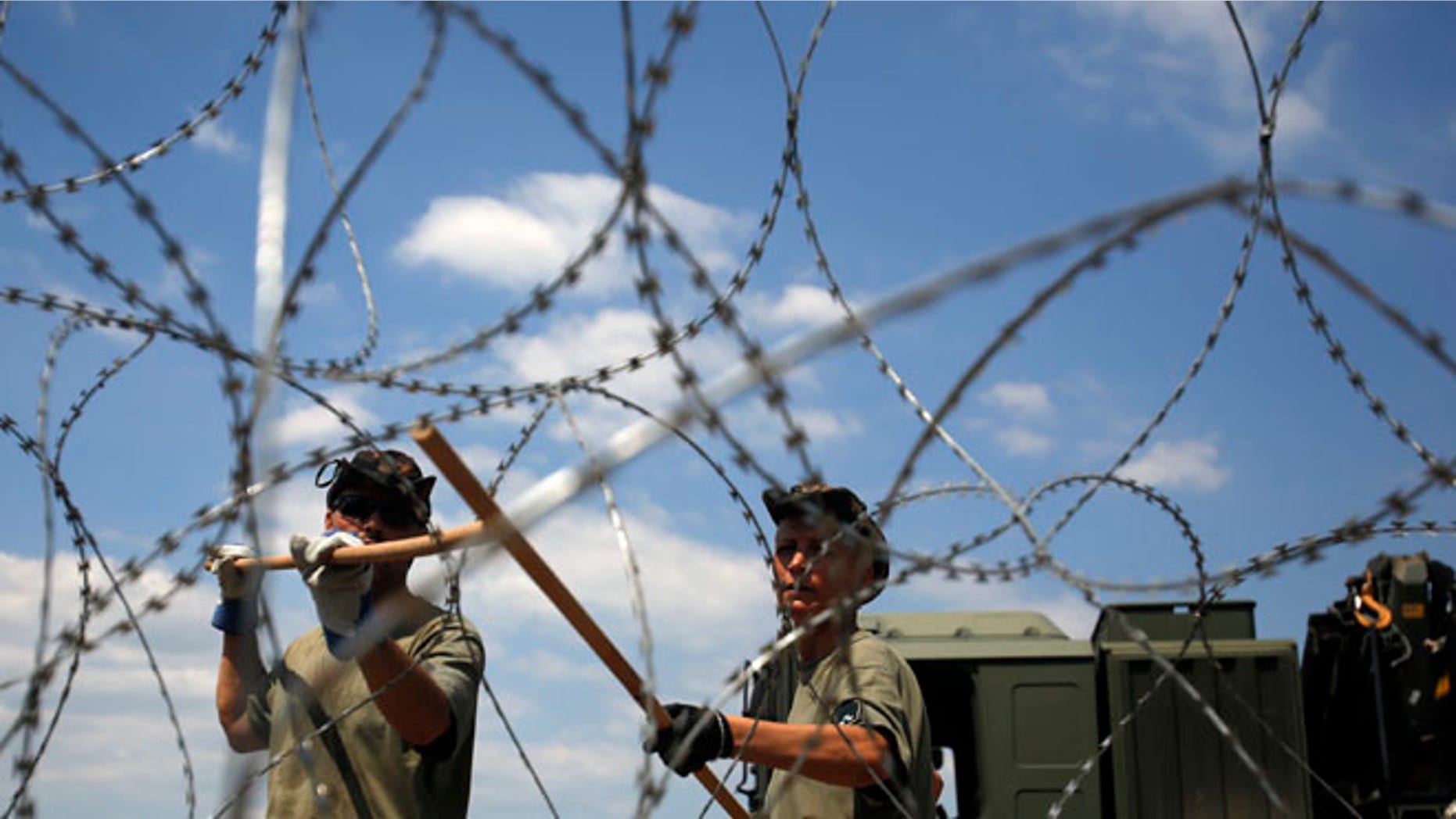 Hungarian soldiers place a barbed wire near Morahalom, Hungary.