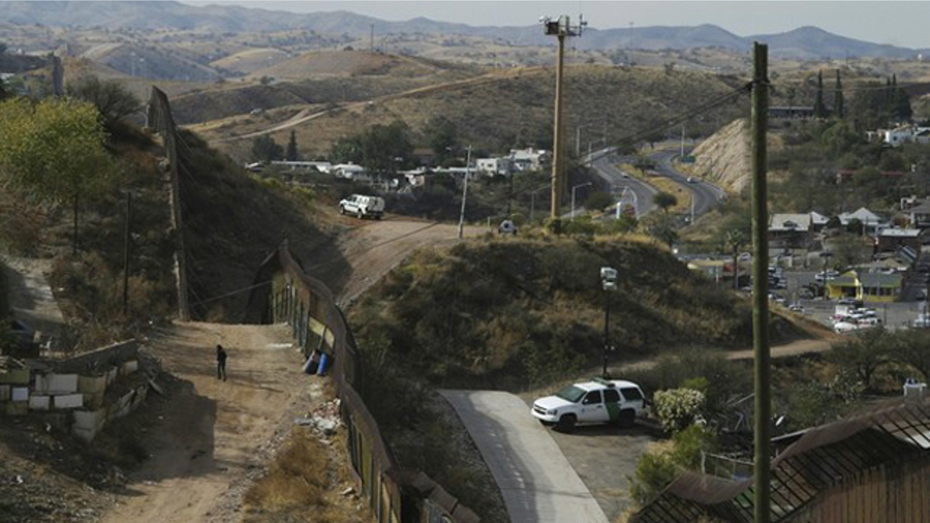 U.S. Border Patrol vehicles are seen from Nogales, Mexico, as they are parked near the border fence between the U.S. and Mexico Jan. 6.