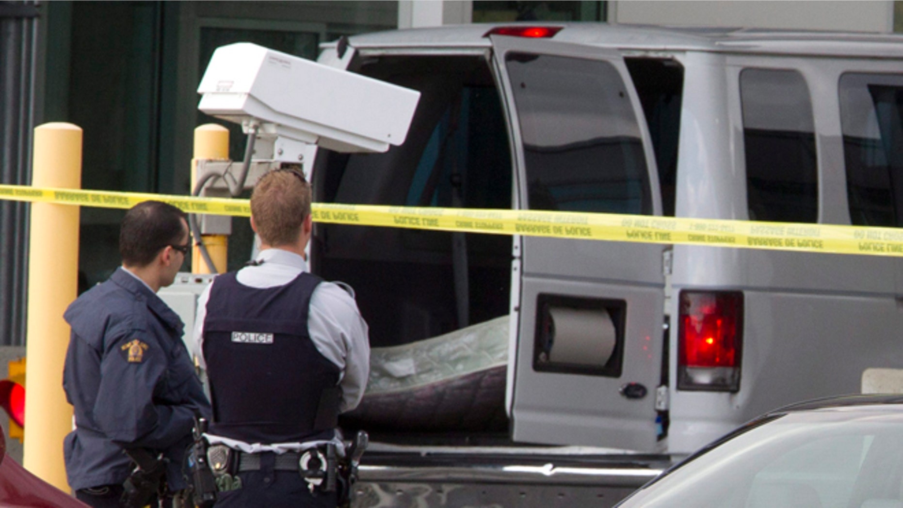 Oct. 16, 2012: Police investigate a van at the scene of a shooting at the Blaine, Wash./Surrey, British Columbia border crossing in Surrey.