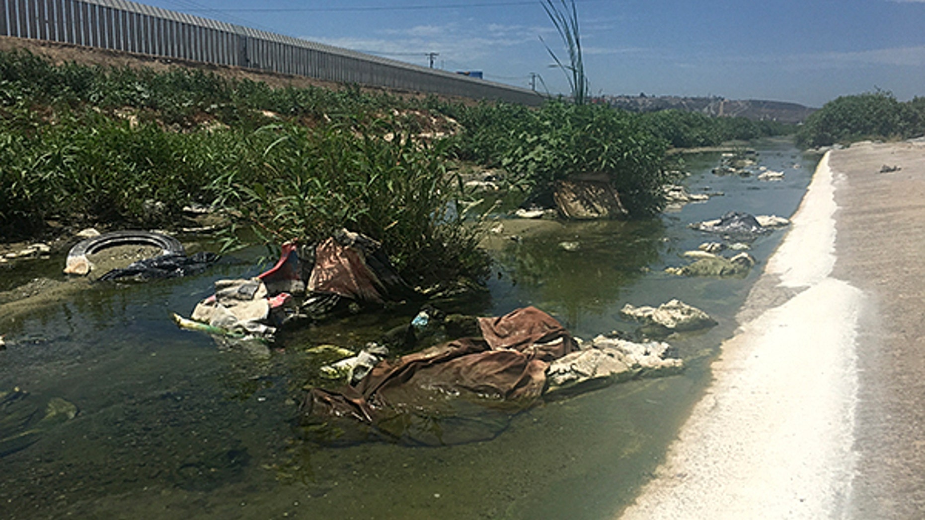 The Tijuana River, polluted with raw sewage, debris, and toxic waste and chemicals, flows into the ocean.