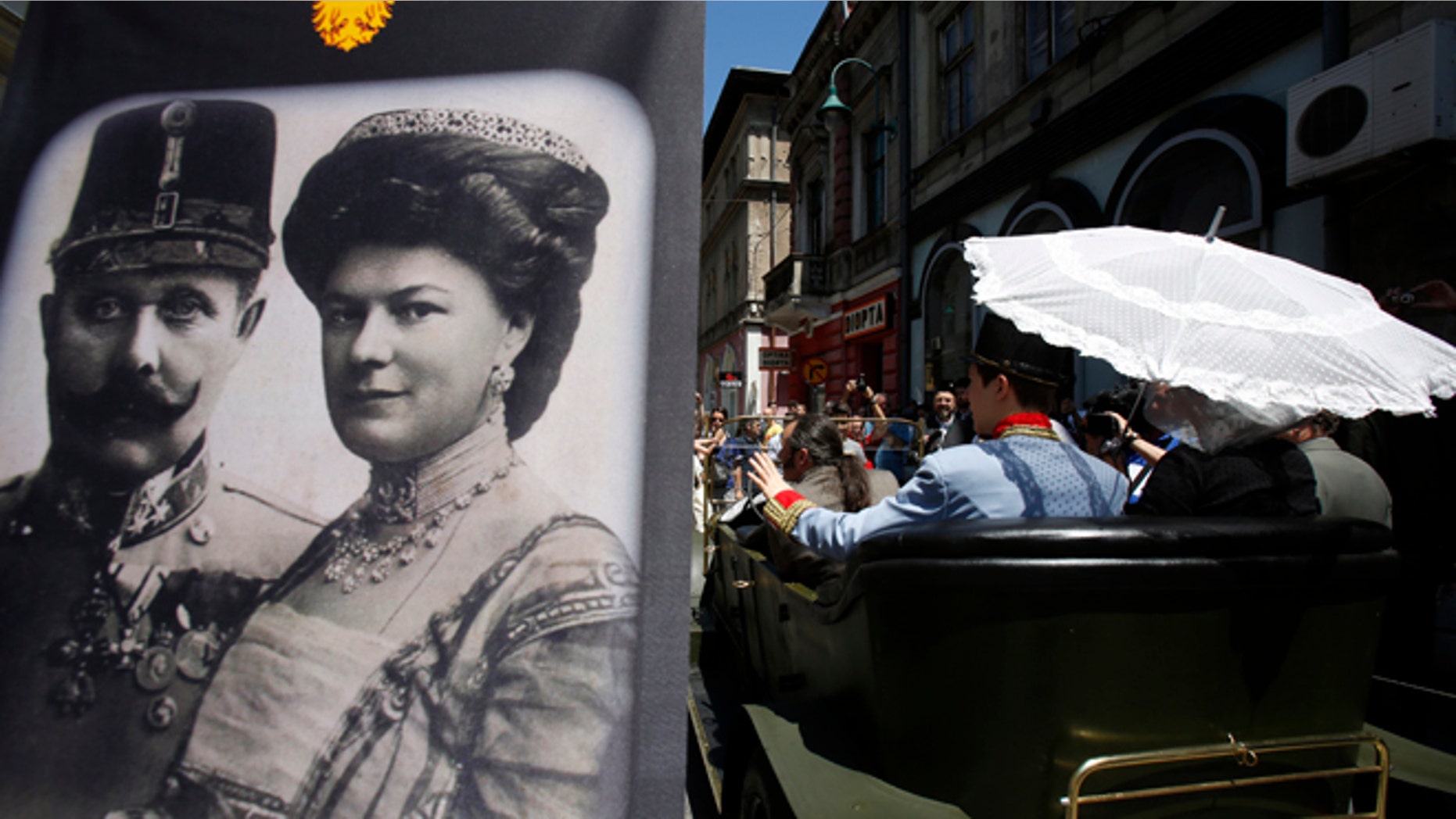 June 28, 2014: Tourists pose for photos inside a replica of the "Graf & Stift" car, parked in front of a museum at the historical street corner in downtown Sarajevo, where Gavrilo Princip assassinated Austro-Hungarian heir to the throne Archduke Franz Ferdinand, in Sarajevo.