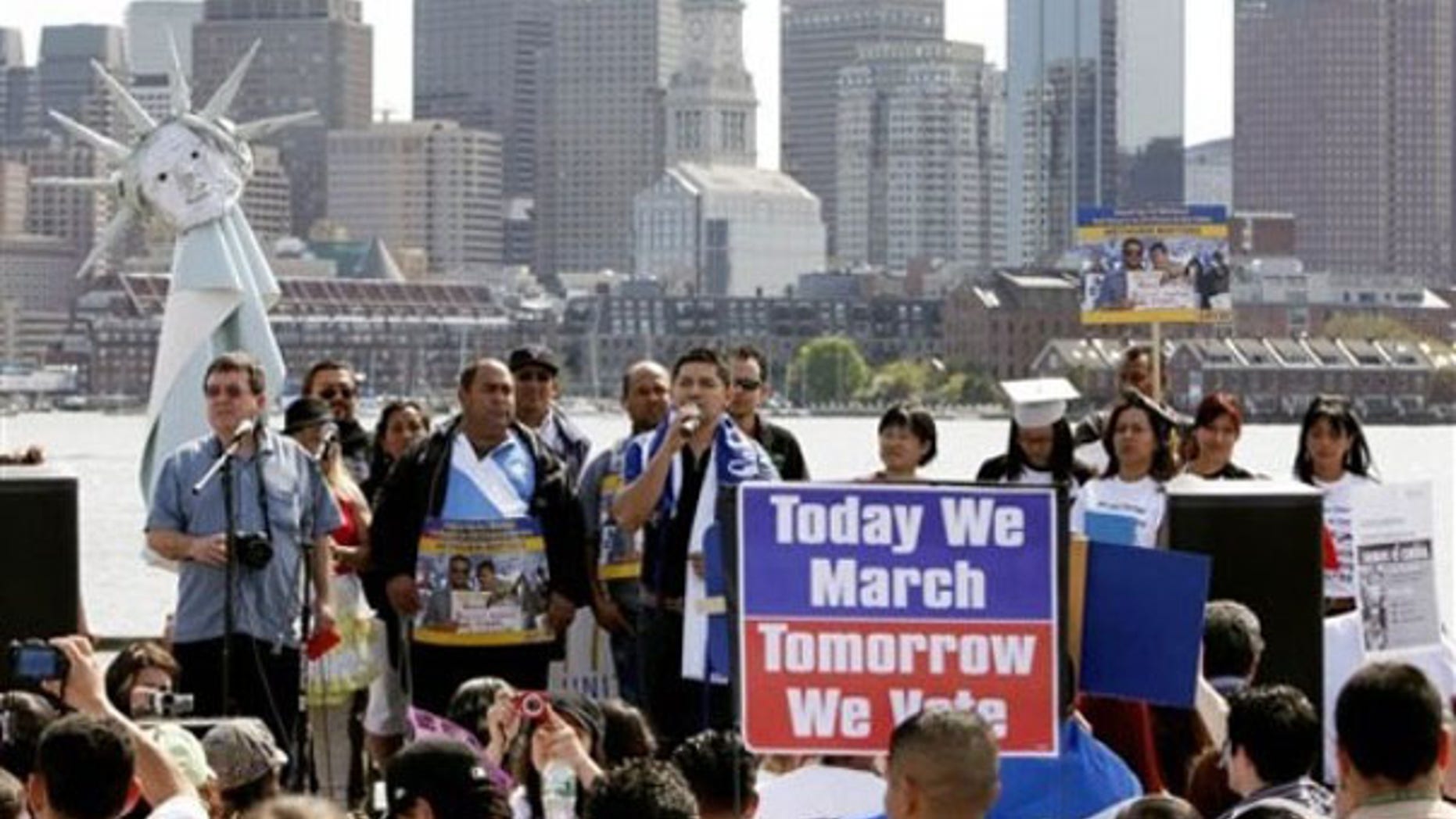 Protesters gather across the harbor from downtown Boston to demand immigration reform and denounce the controversial Arizona immigration law May 1. (AP Photo)