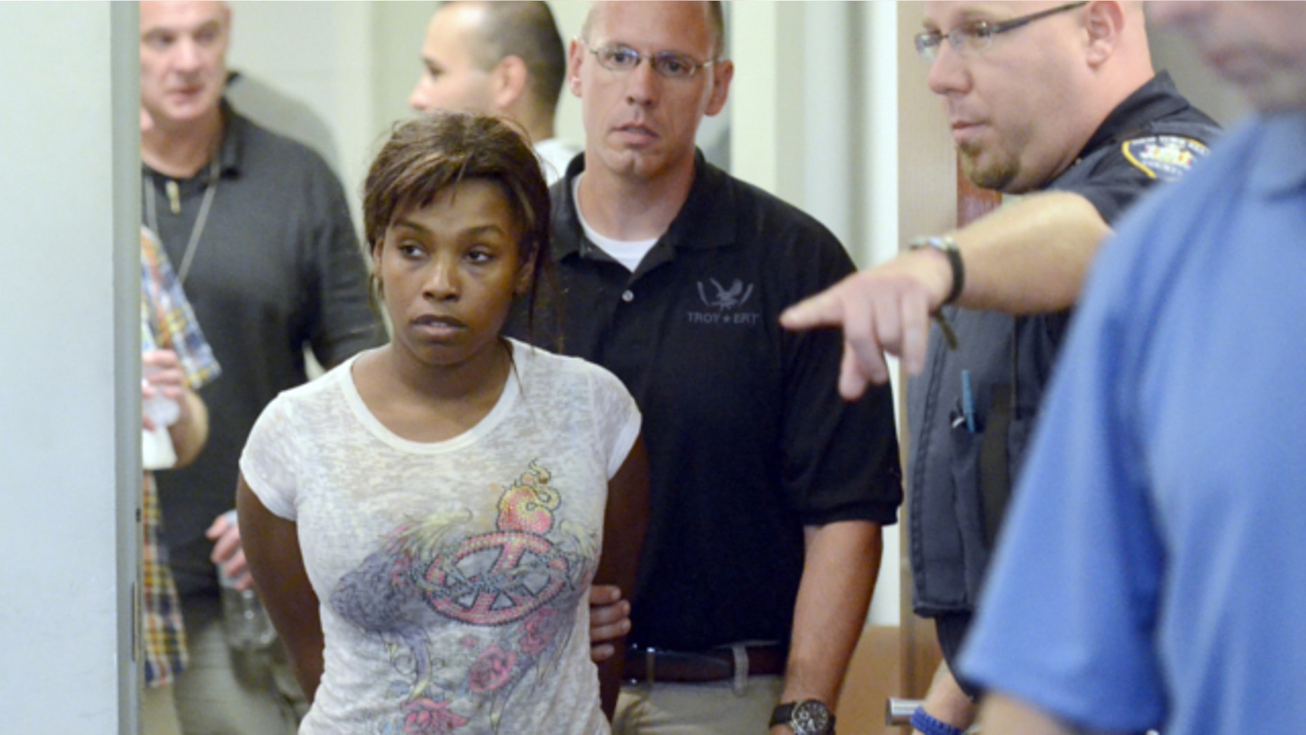 July 19, 2013: Audrea Gause, 26, of Troy, N.Y., is led into court in Troy, N.Y. to be arraigned on a Massachusetts fugitive warrant for defrauding the One Fund Boston of $480,000.