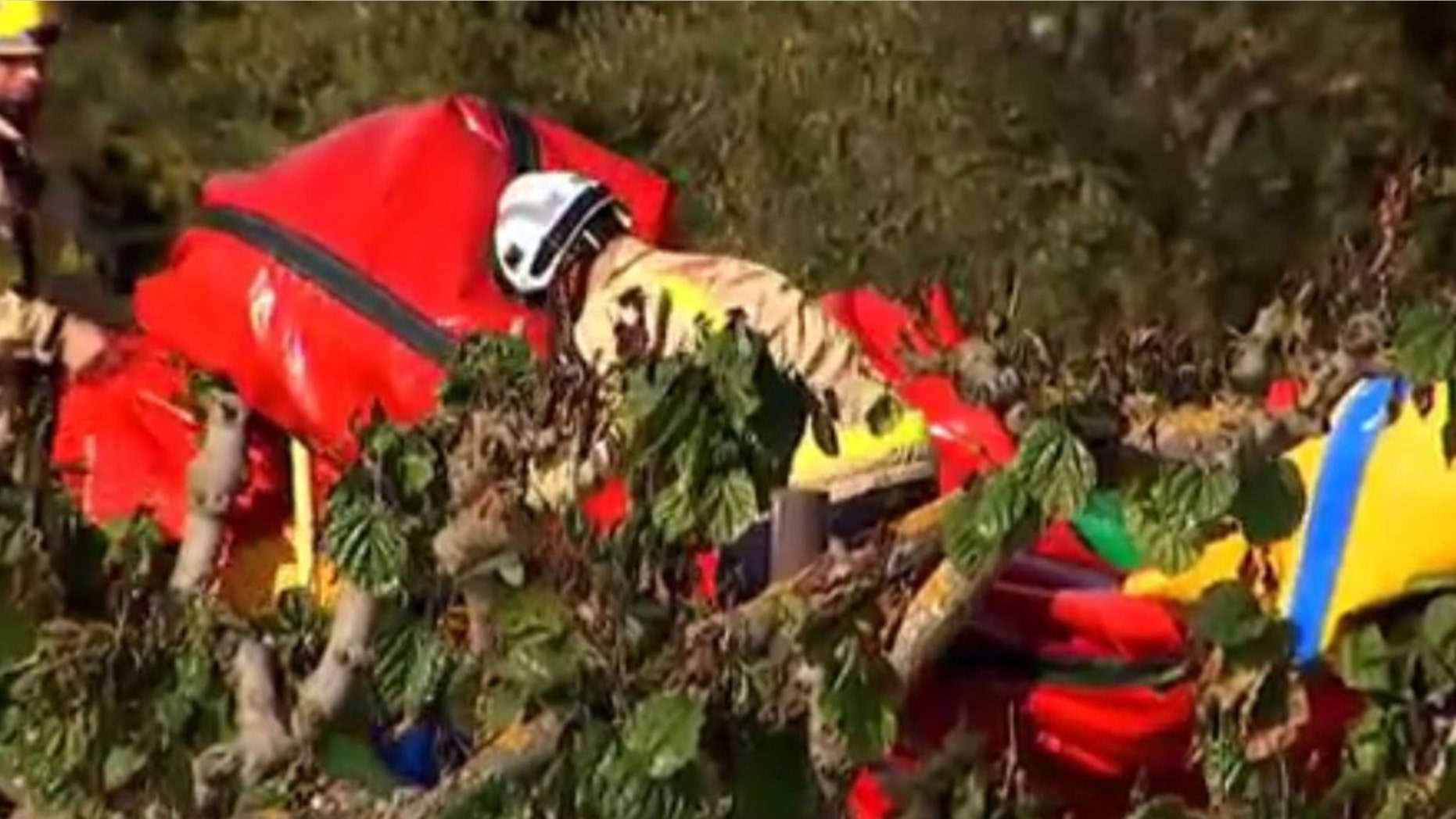 Firefighters remove debris following the bouncy castle explosion in Spain.