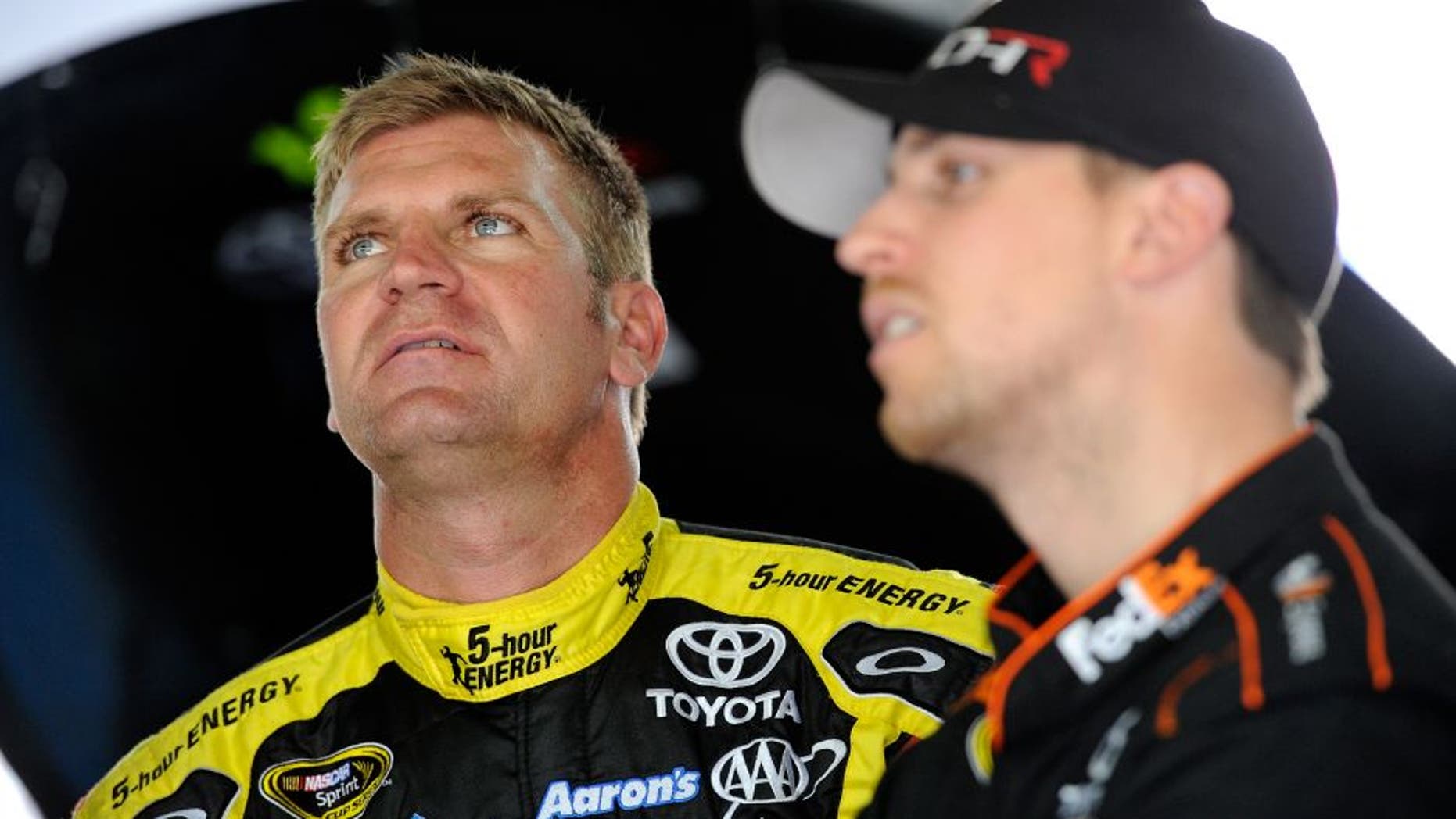 CHARLOTTE, NC - MARCH 11: Denny Hamlin(right), driver of the #11 FedEx Toyota, and Clint Bowyer, driver of the #15 5-Hour Energy Toyota, look over data in the garage area during the NASCAR Sprint Cup Series test at Charlotte Motor Speedway on March 11, 2015 in Charlotte, North Carolina. (Photo by Jared C. Tilton/NASCAR via Getty Images)