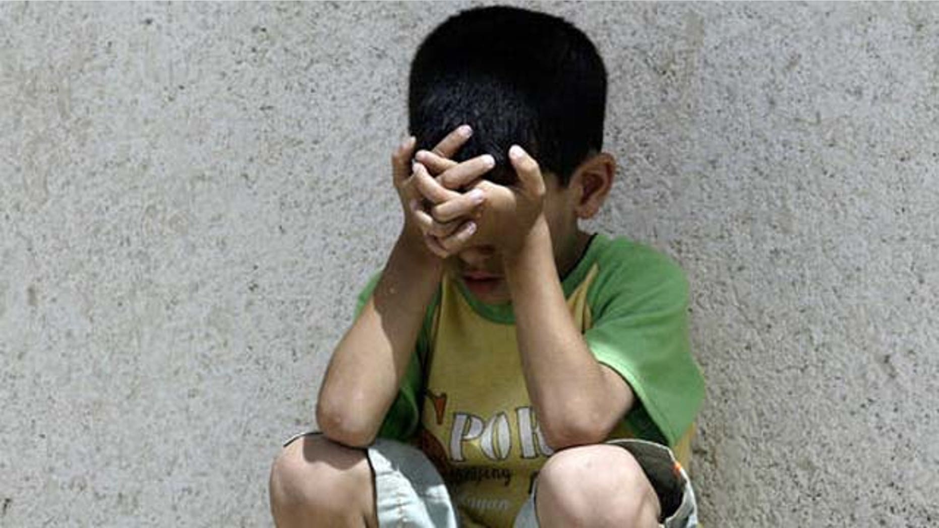 A young Iraqi boy grieves for relatives killed by a car bomb as their bodies are taken away to be buried in the Shiite holy city of Najaf, 160 kilometers (100 miles) south of Baghdad, Iraq Wednesday, July 18, 2007. The attack in Baghdad on Monday followed the release of a man who was kidnapped on Sunday night, police said. The man drove home and parked his car, which exploded and killed his daughters, 18 and 21, and injured his 11-year-old son. (AP Photo/Alaa al-Marjani)