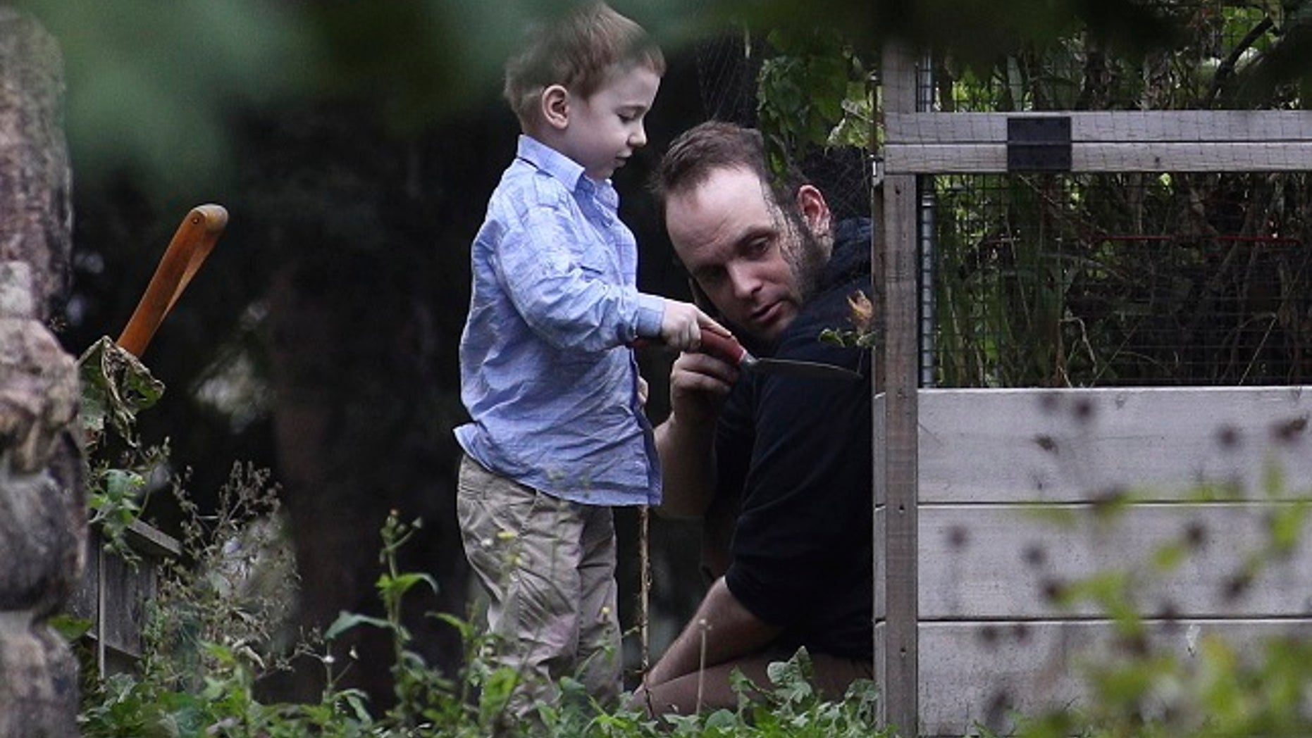 Joshua Boyle and his son Jonah play in the garden at his parent's house in Smiths Falls, Ontario, on Saturday, Oct. 14, 2017.