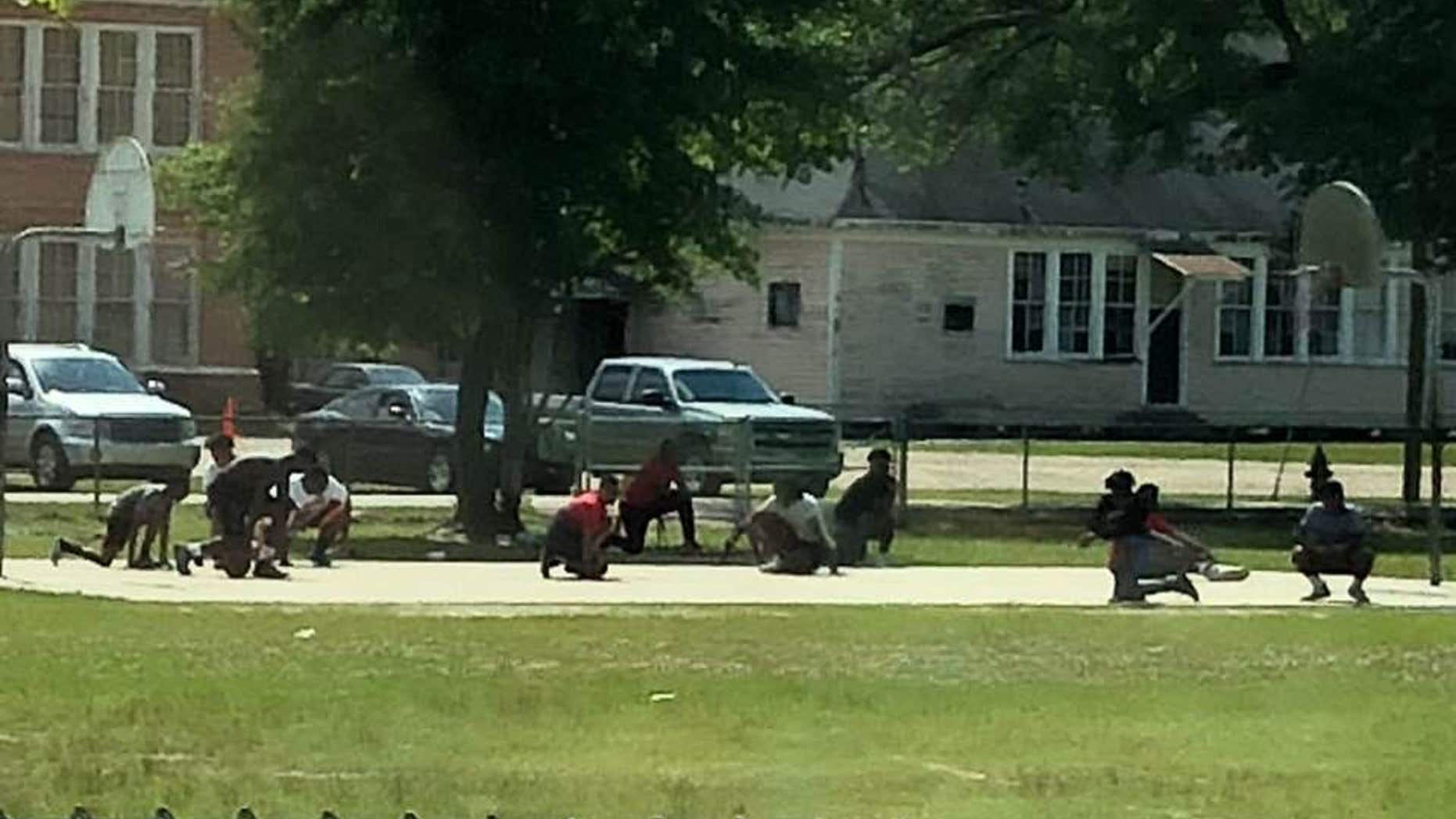 A group of teens dropped to their knees in Franklinton, Louisiana, when they saw a funeral procession passing by.