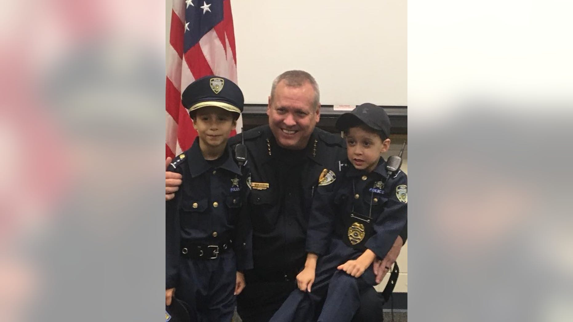 Kissimmee Police Sgt. Sam Howard and Enzo Russell (left) pose for a picture after the 6-year-old was "sworn in."