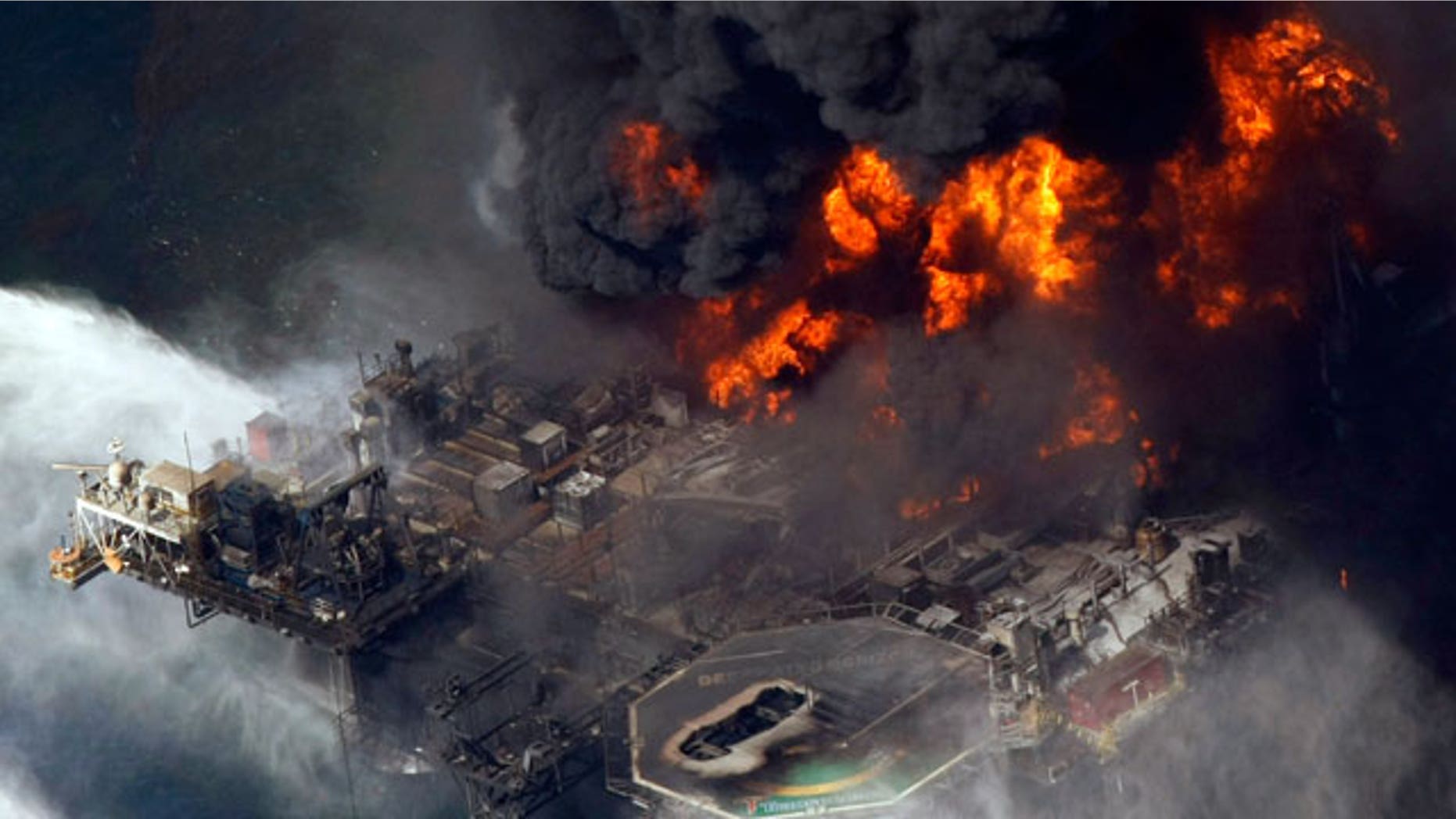 In this April 21, 2010 file aerial photo taken in the Gulf of Mexico more than 50 miles southeast of Venice, La., the Deepwater Horizon oil rig is seen burning.