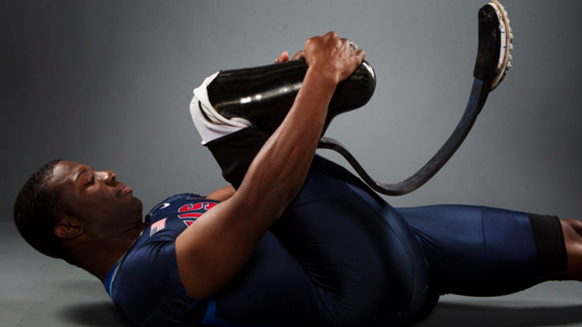 Paralympic sprinter Jerome Singleton stretches while posing for a portrait during the 2012 U.S. Olympic Team Media Summit in Dallas, Texas May 15, 2012. REUTERS/Lucas Jackson