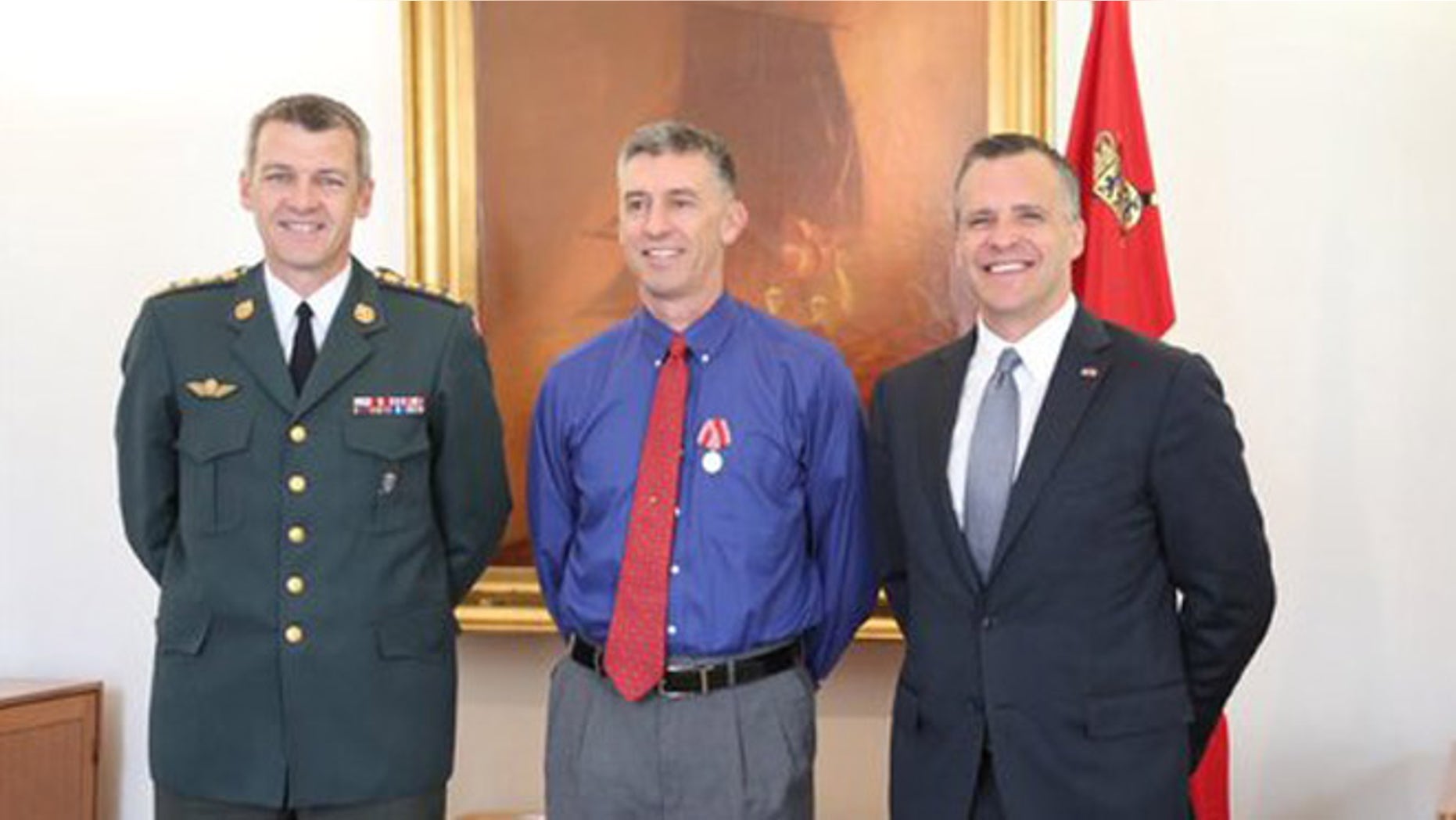 Danish Defense head Peter Bartram, U.S. Army Capt. Bradley Grimm and U.S. Ambassador to Denmark Rufus Gifford at Copenhagen medal ceremony. (Department of Defense)