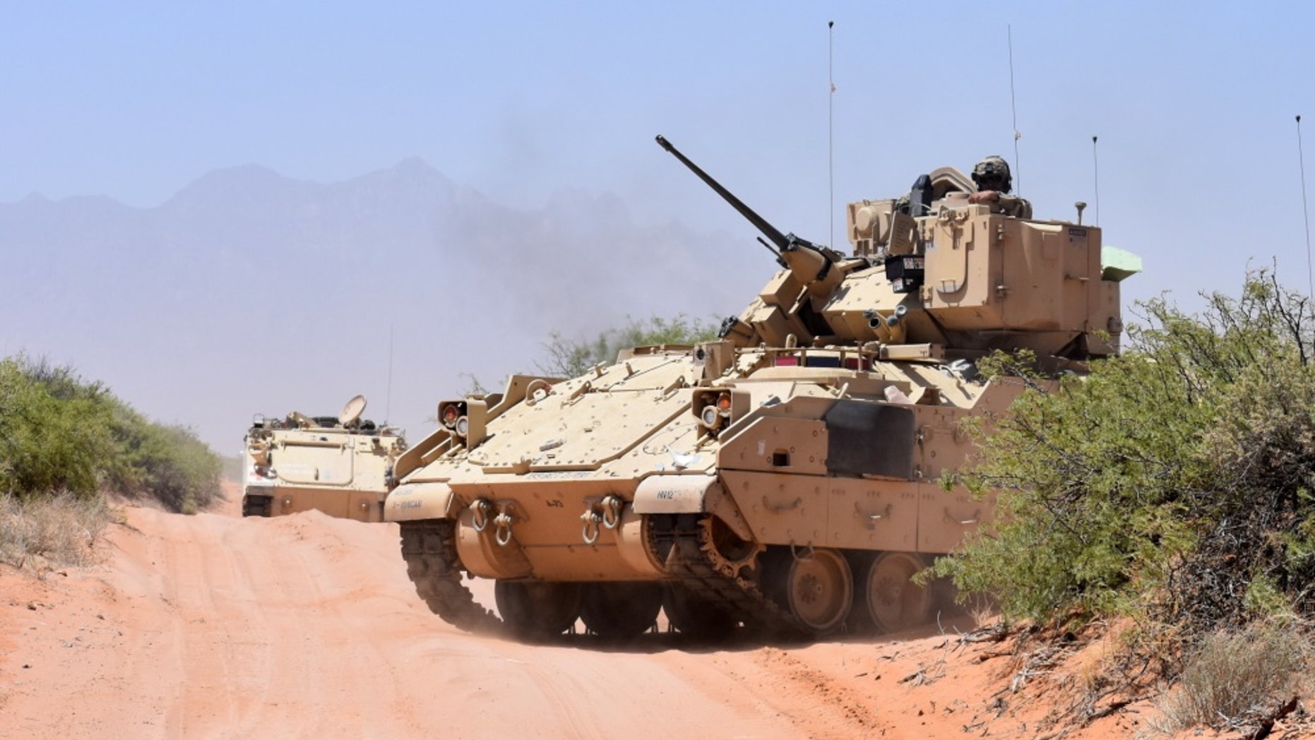 File photo - Soldiers assigned to Company B, 2nd Battalion, 198th Infantry Regiment, 155th Armored Brigade Combat Team, Mississippi Army National Guard, ride in a Bradley Fighting Vehicle after an exercise near the El Jarbah training village on Doña Ana Range, N.M., April 20, 2018. (Winifred Brown, Fort Bliss Public Affairs Office)