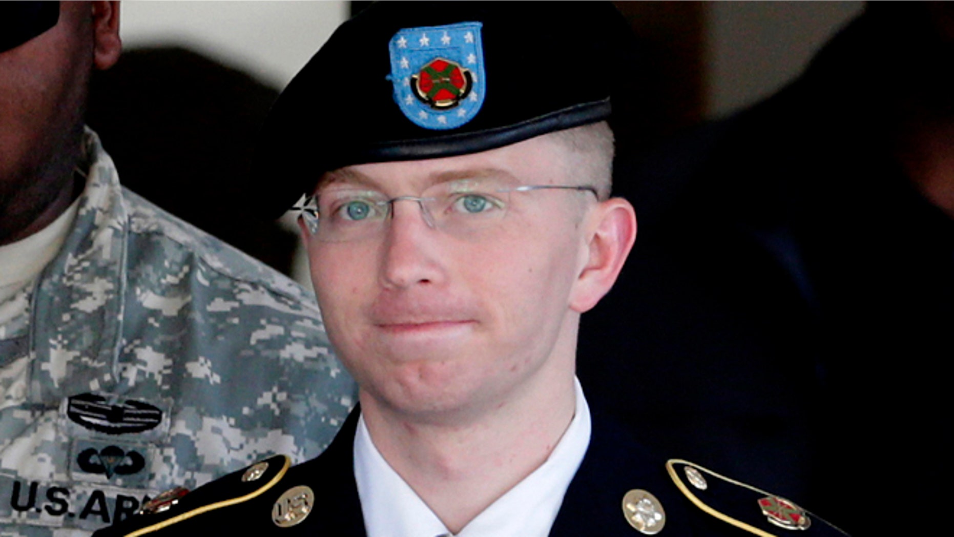 FILE: June 25, 2012: Army Pfc. Bradley Manning, right, is escorted out of a courthouse in Fort Meade, Md.