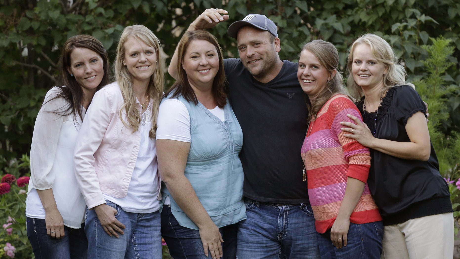 Sept. 11, 2013. Brady Williams poses with his wives, from left to right, Paulie, Robyn, Rosemary, Nonie, and Rhonda, outside of their home in a polygamous community outside Salt Lake City.