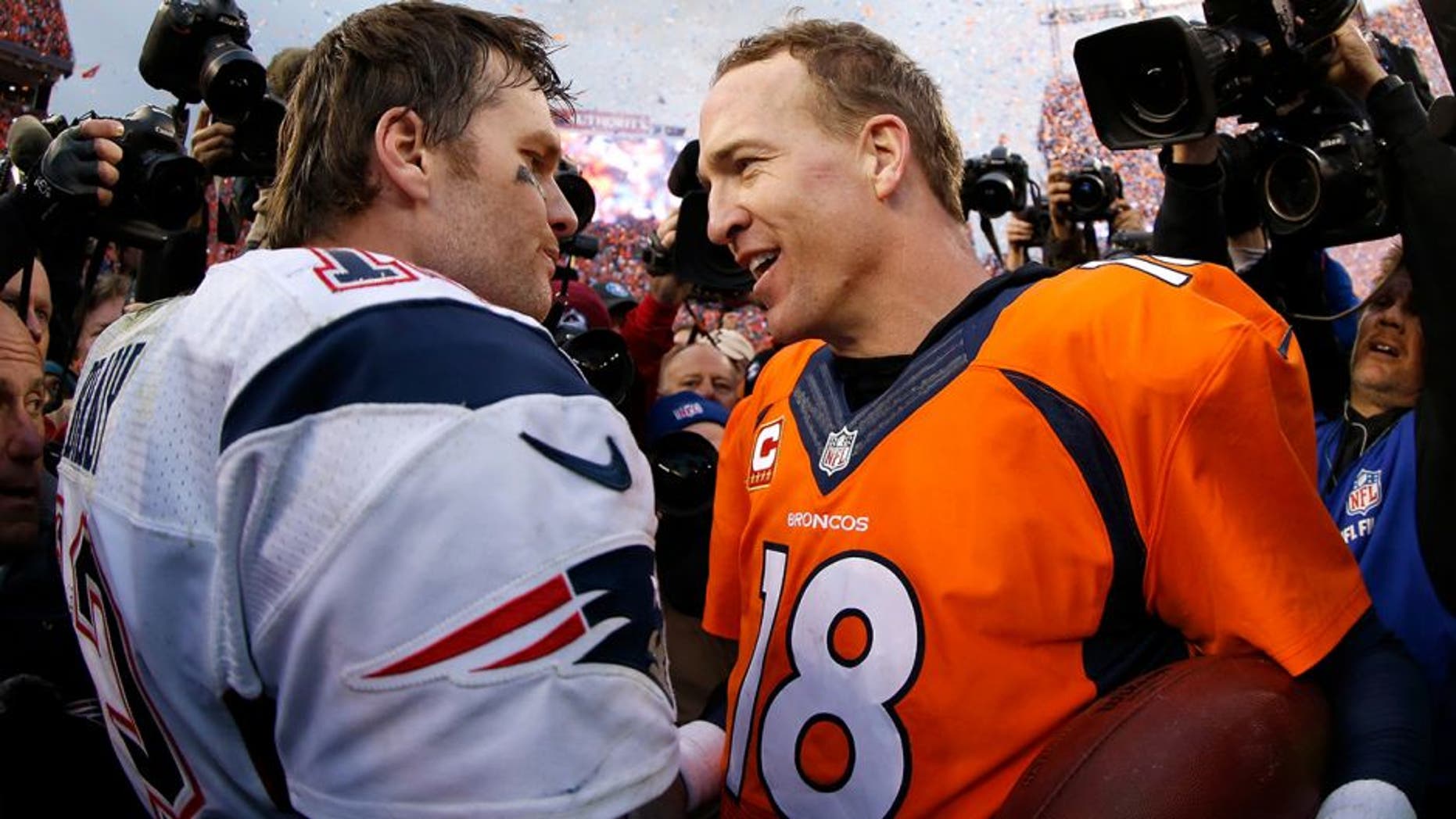 DENVER, CO - JANUARY 24: Peyton Manning #18 of the Denver Broncos and Tom Brady #12 of the New England Patriots speak after the AFC Championship game at Sports Authority Field at Mile High on January 24, 2016 in Denver, Colorado. The Broncos defeated the Patriots 20-18. (Photo by Ezra Shaw/Getty Images)