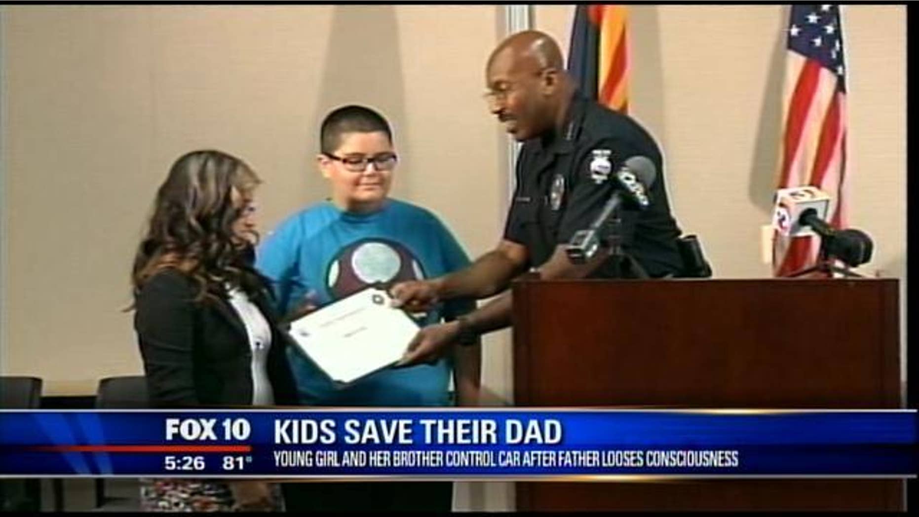 Apr. 15, 2013: Kylah Woody, 13, and her brother Michael, 11, are presented with the Peoria Police Department's bravery award in Peoria, Ariz.