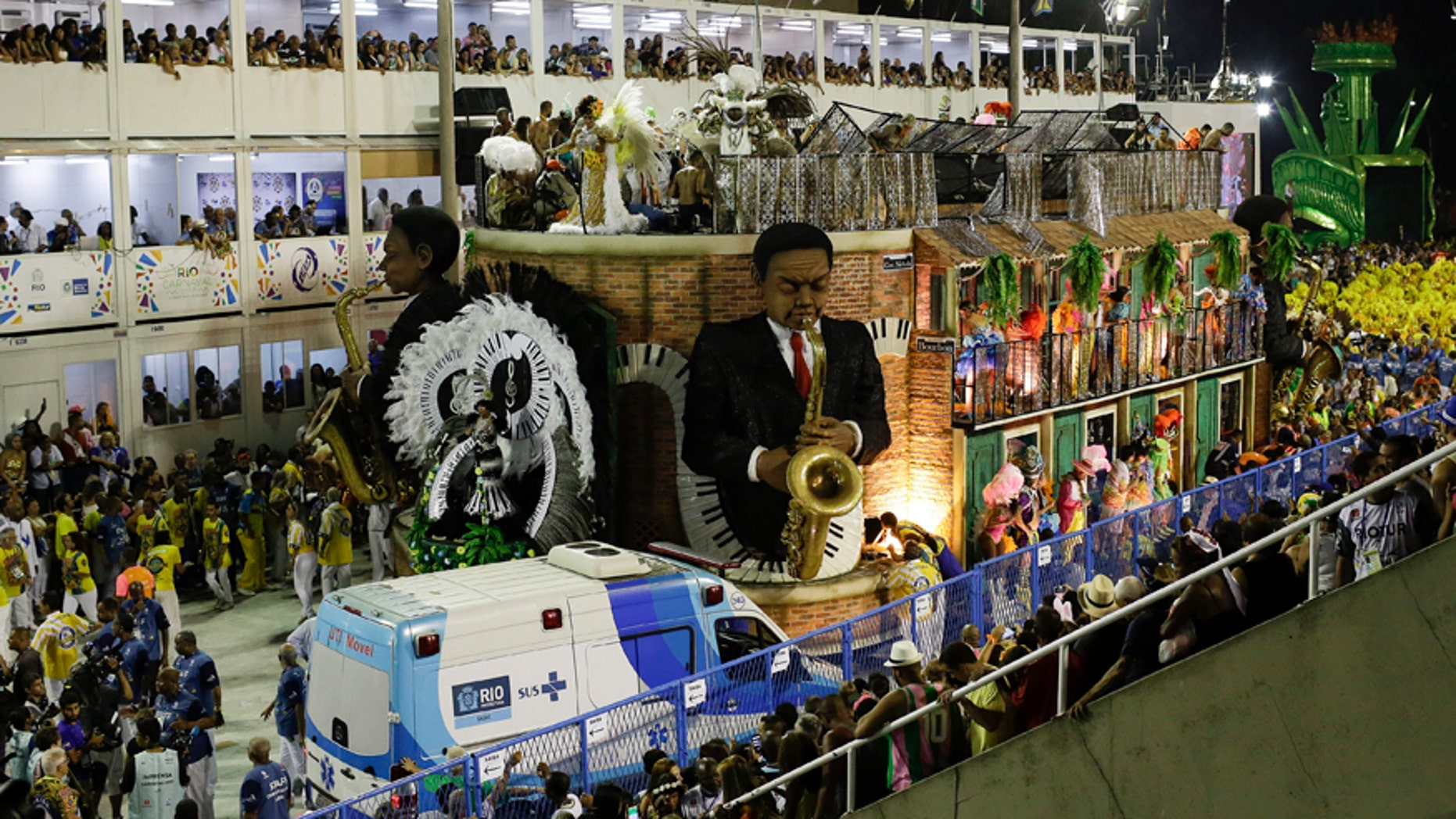 An ambulance parks in front the a float as people are rescued after an accident during the performing of the Unidos da Tijuca samba school for the Carnival celebrations at the Sambadrome in Rio de Janeiro, Brazil, Tuesday, Feb. 28, 2017. Part of the float has collapsed during Rio de Janeiro's world famous Carnival parade, injuring more than a dozen of people, according to doctors at the scene. (AP Photo/Leo Correa)