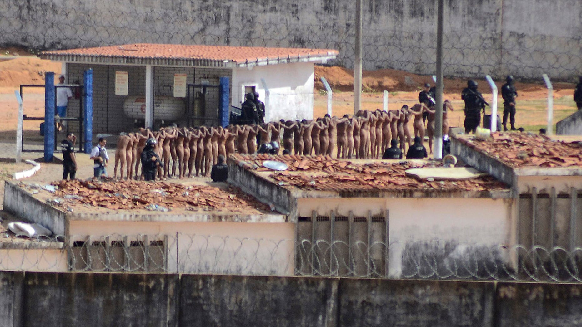 Jan. 15, 2017: Naked inmates stand in line while surrounded by police after a riot at the Alcacuz prison in Nisia Floresta, Rio Grande do Norte state, Brazi.