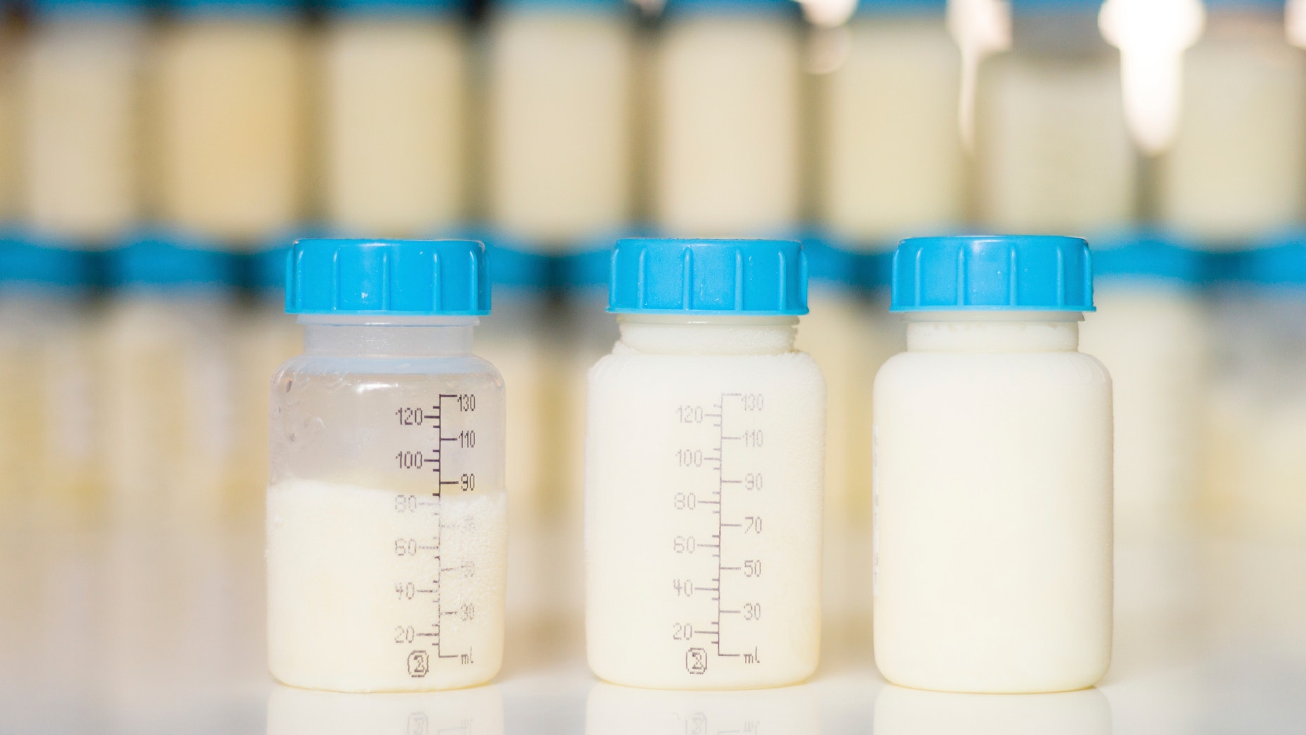 Breastfeeding and storage: Frozen mother milk with ice around the bottle freshly taken out of the freezer.