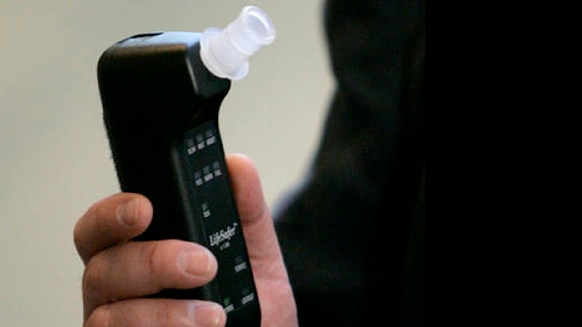 Richard Freund, president of LifeSafer Interlock, holds the company's breath-alcohol analyzer during a news conference, Wednesday, Aug. 22, 2007, in Washington. (AP Photo/Haraz N. Ghanbari)