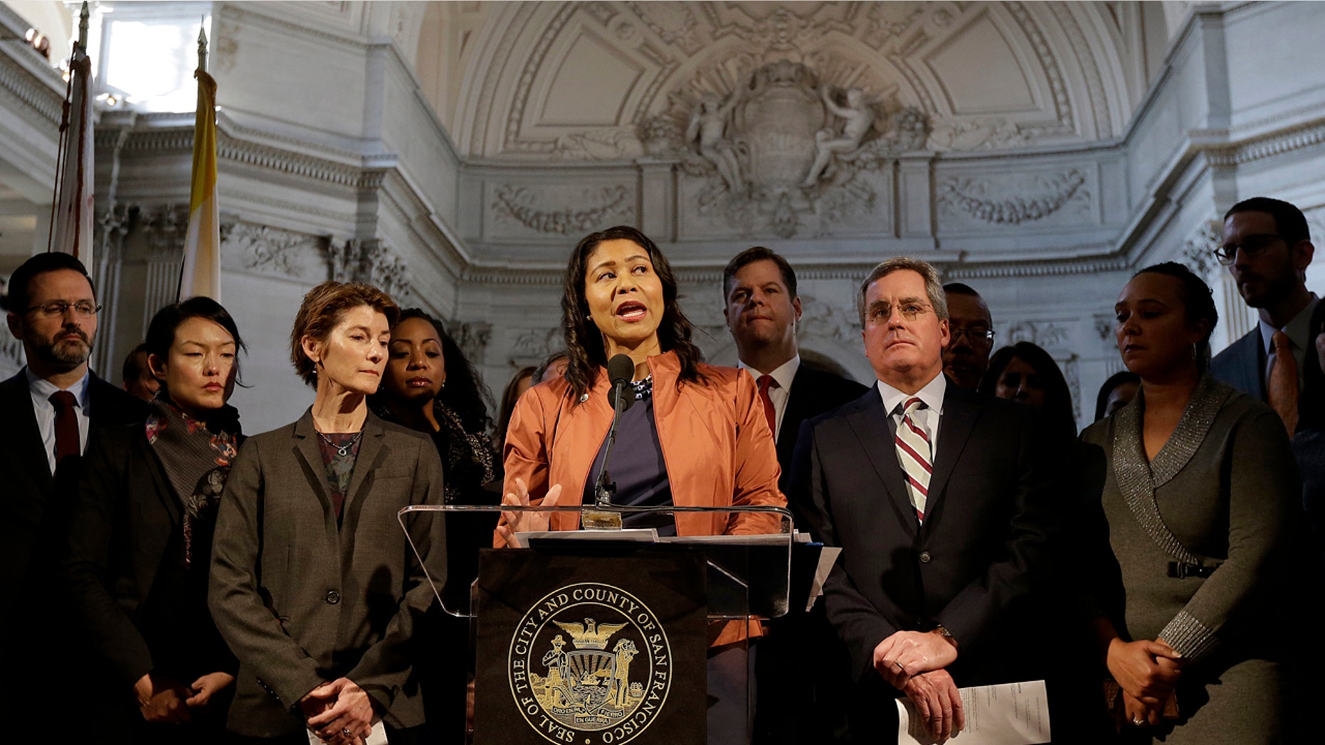 San Francisco Acting Mayor London Breed, center, speaks at a news conference at City Hall in San Francisco, Dec. 12, 2017.